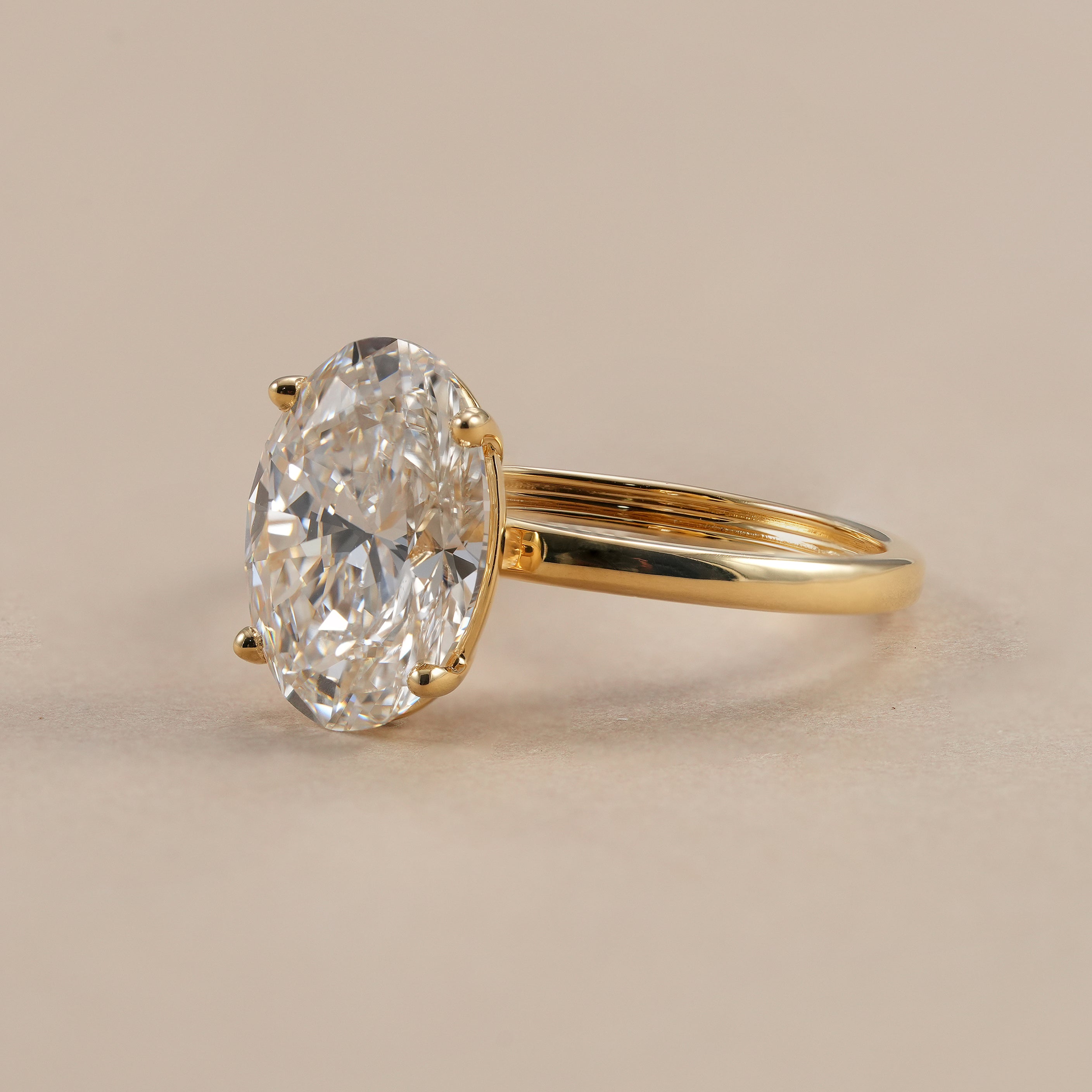 Oval lab grown diamond engagement ring with classic solitaire setting.