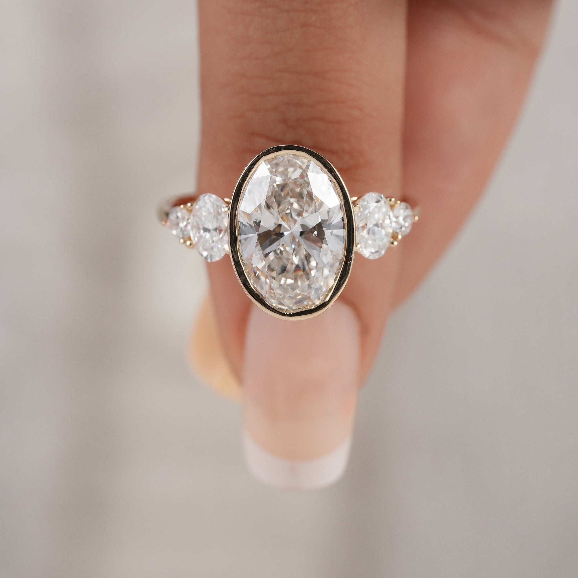 Modern bezel set oval diamond ring for everyday elegance