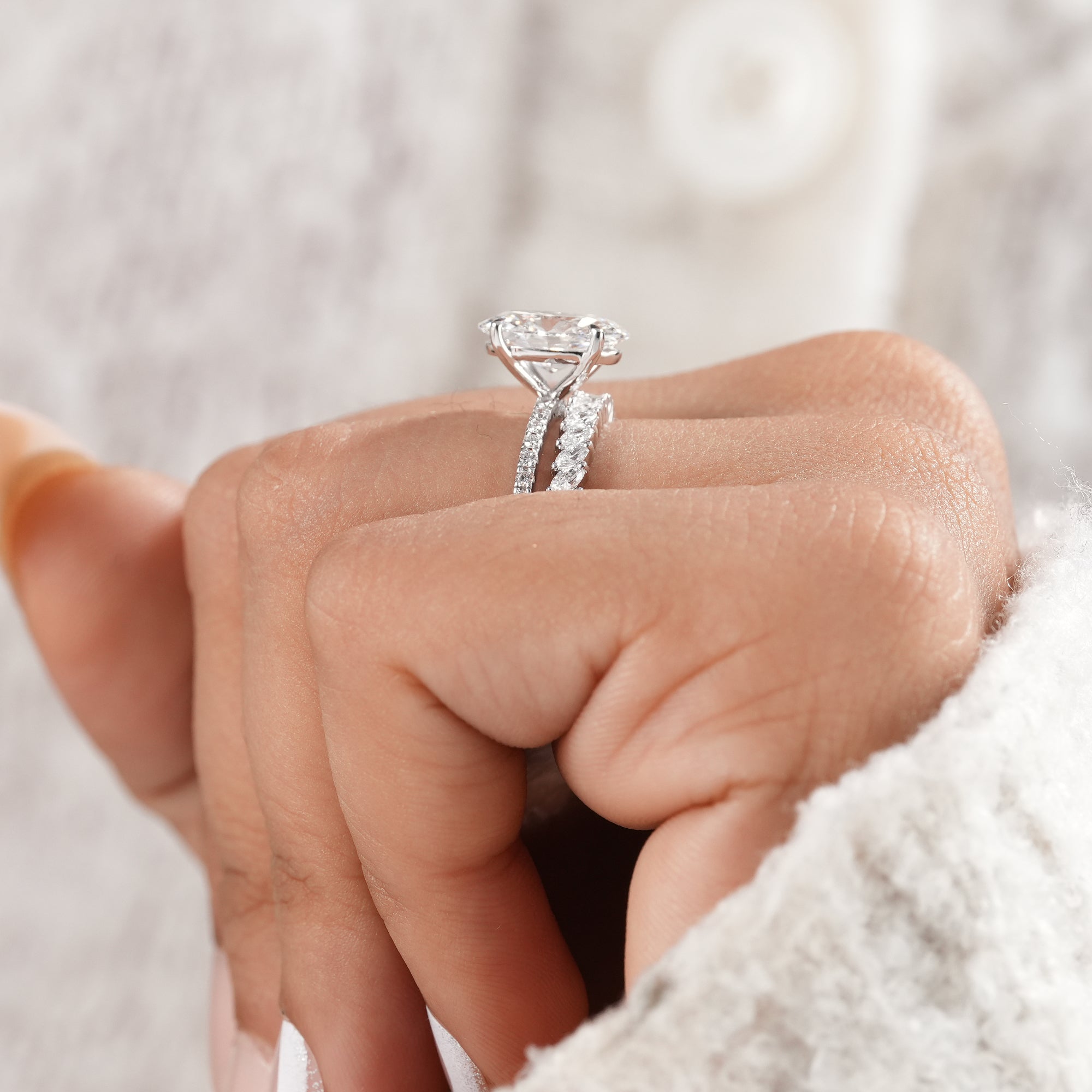 White gold oval lab diamond engagement ring and matching band.
