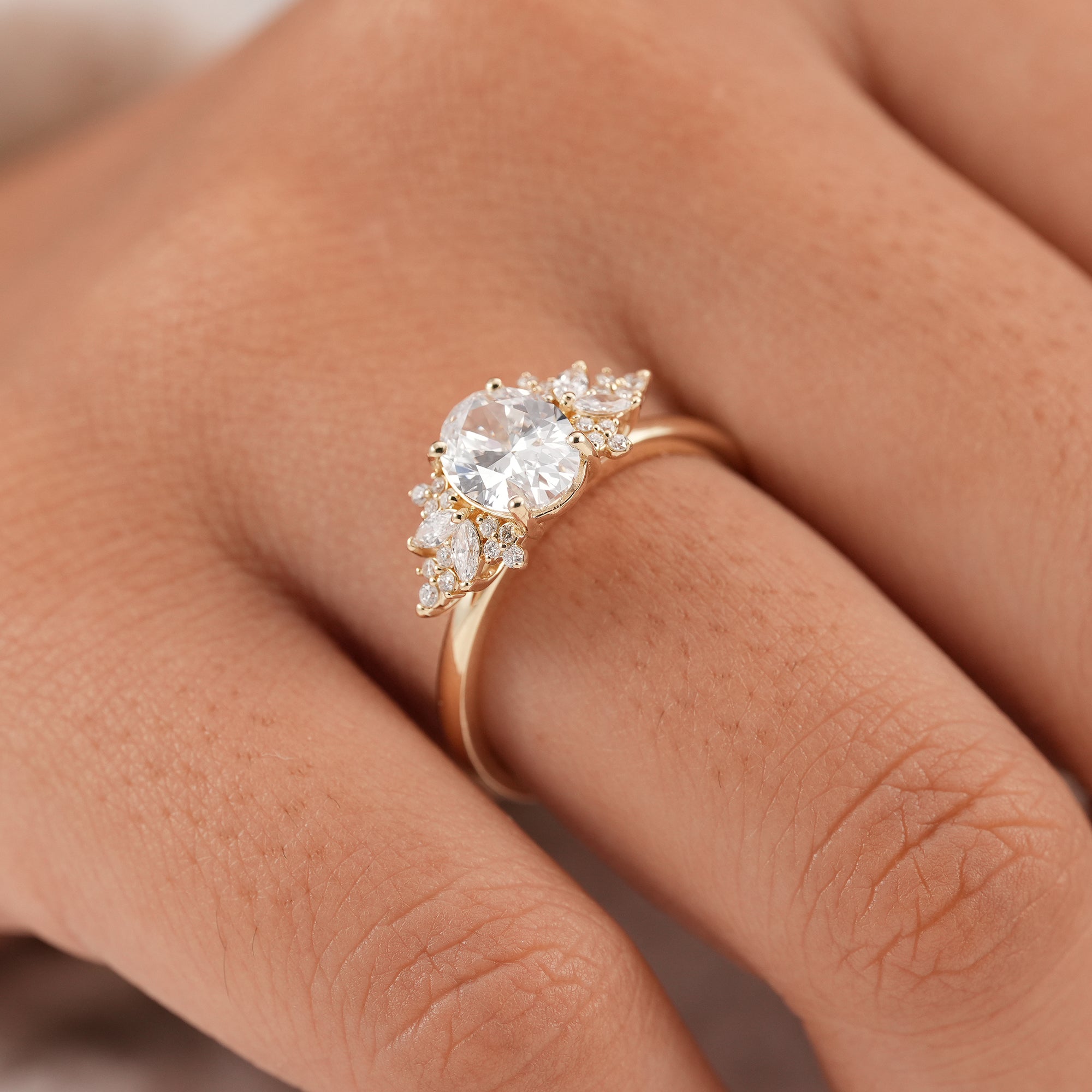 Women's oval diamond anniversary ring with sparkling floral cluster