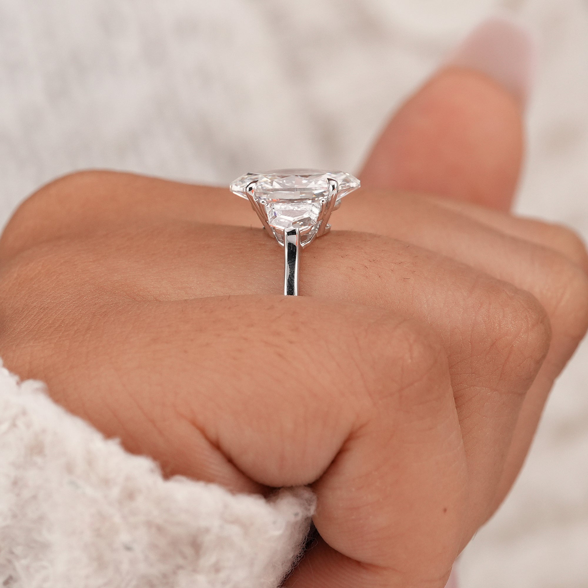 Oval diamond engagement ring featuring Cadillac side stones and IGI certified center diamond