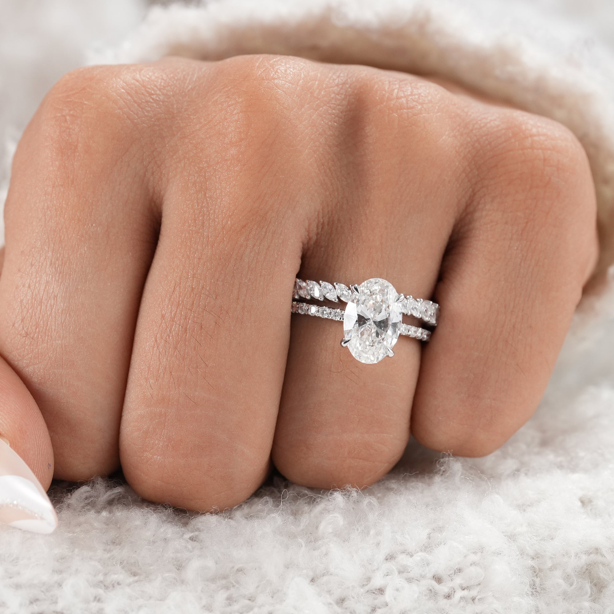 Fine jewelry oval engagement ring with pavé diamond band.
