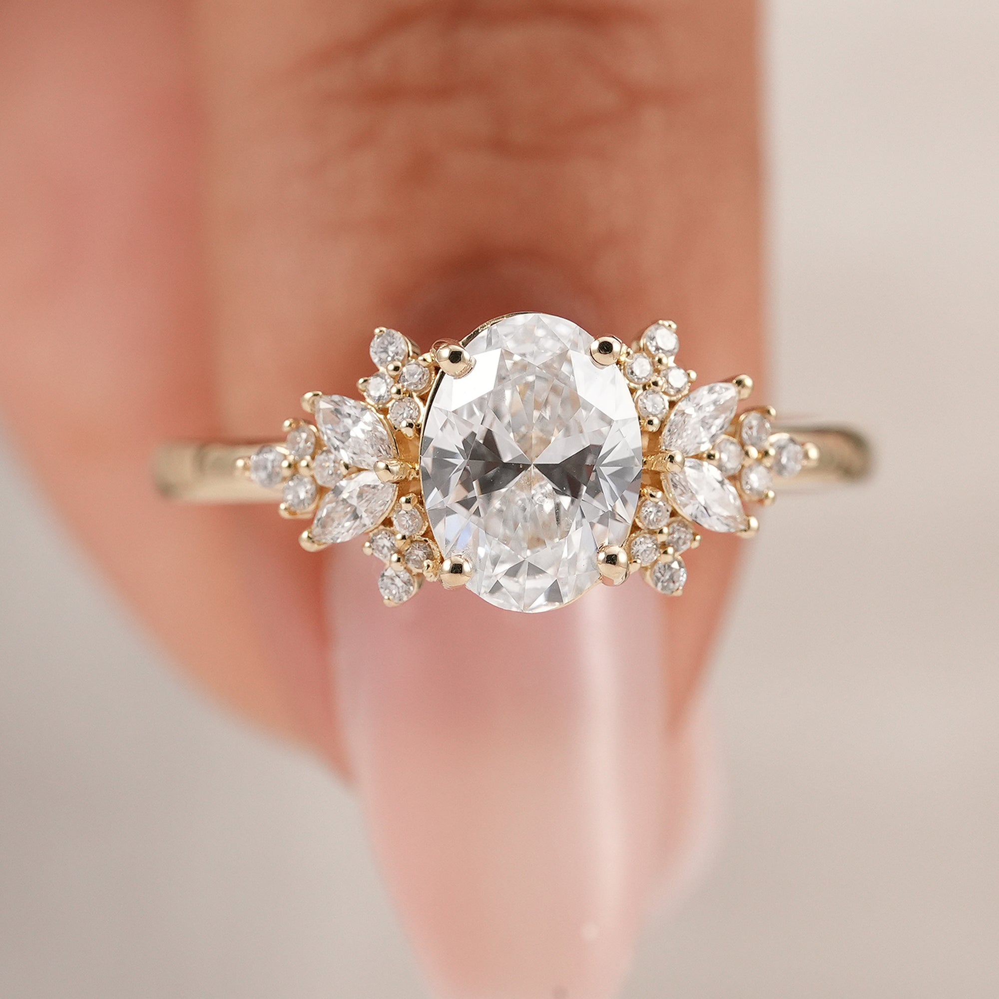 Elegant oval diamond bridal ring with round and marquise side diamonds