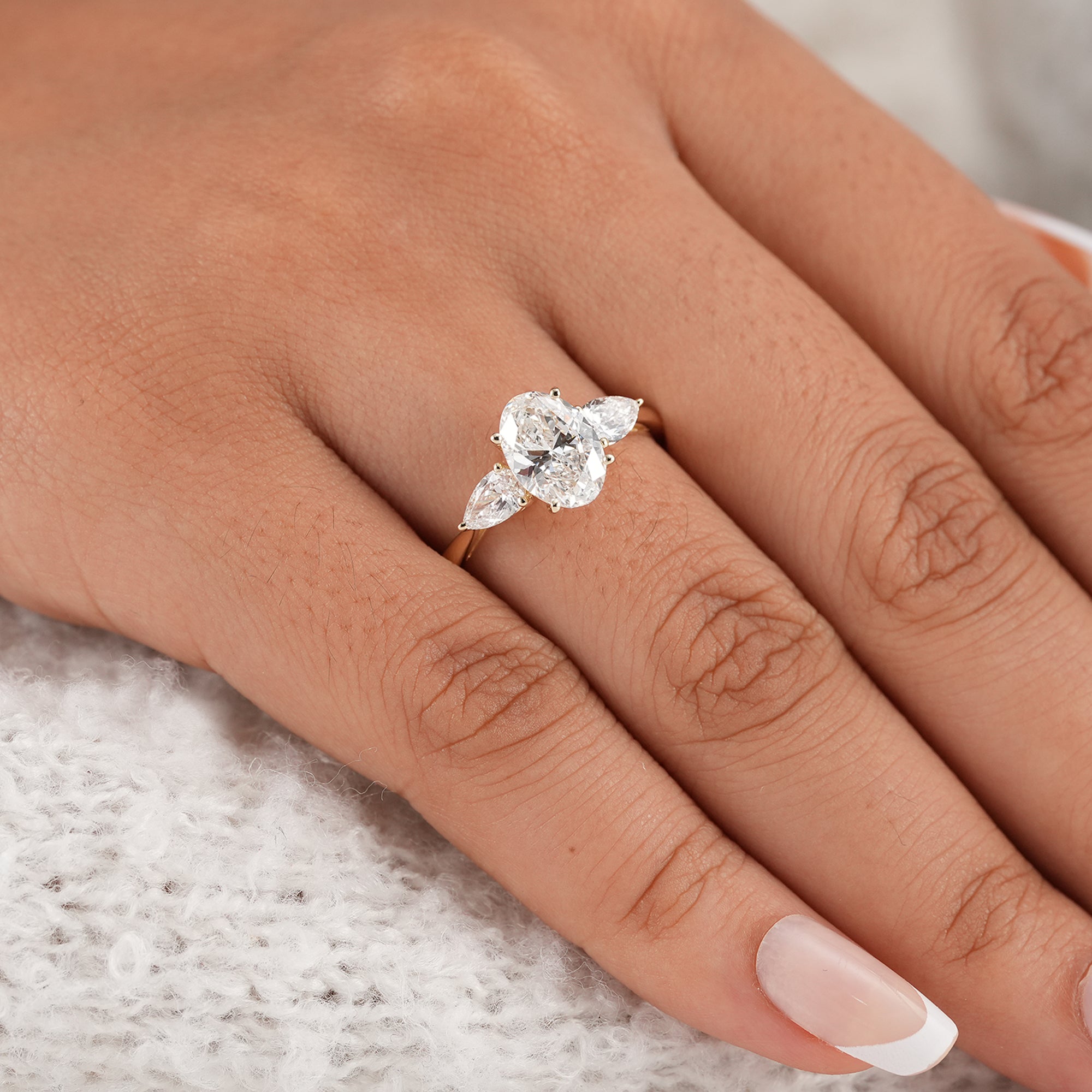 Oval trilogy diamond ring with pear accent stones