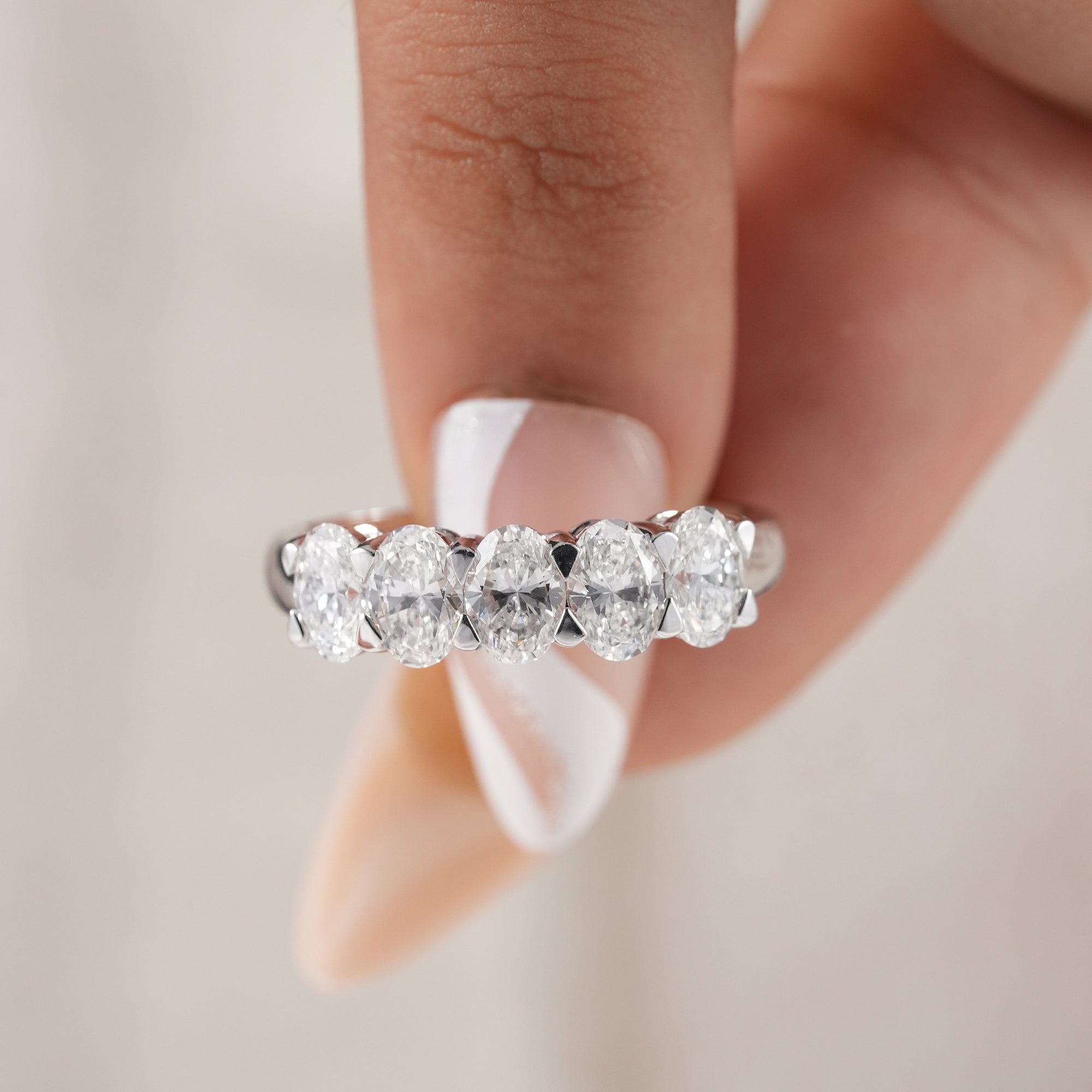 Minimalist five stone oval diamond bridal band.