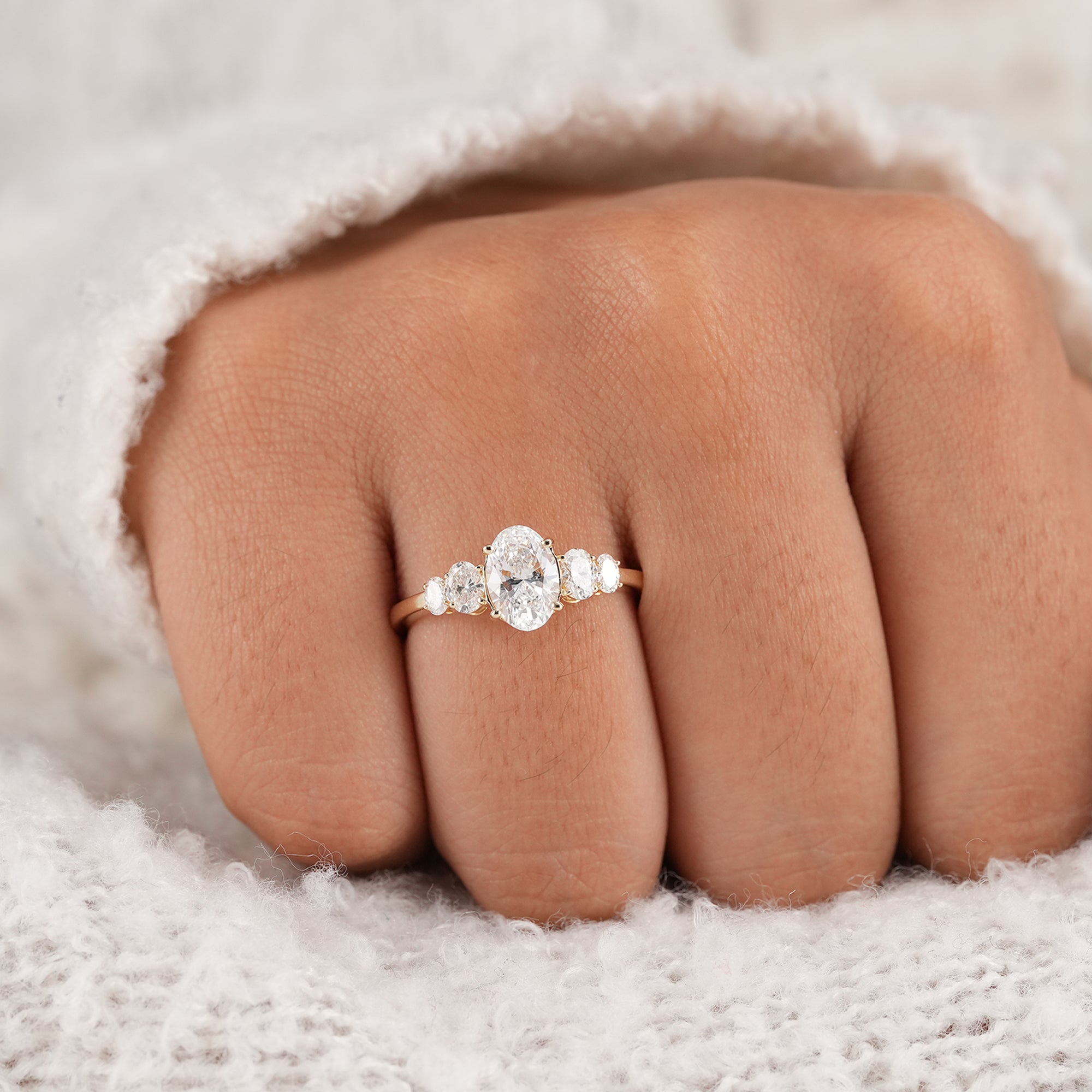 Oval lab diamond engagement ring with graduated side stones