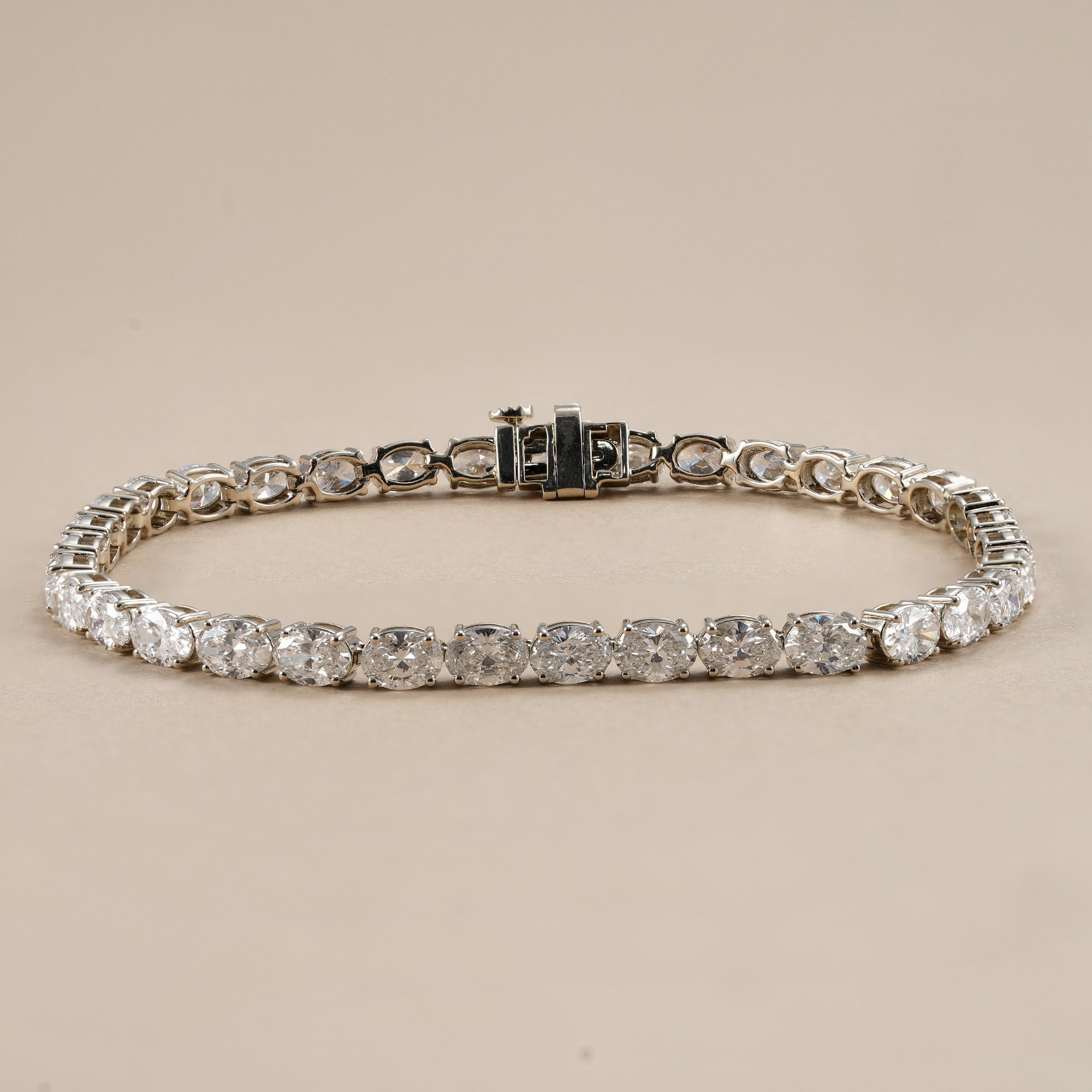 Oval lab diamond tennis bracelet with elegant east west diamond setting.