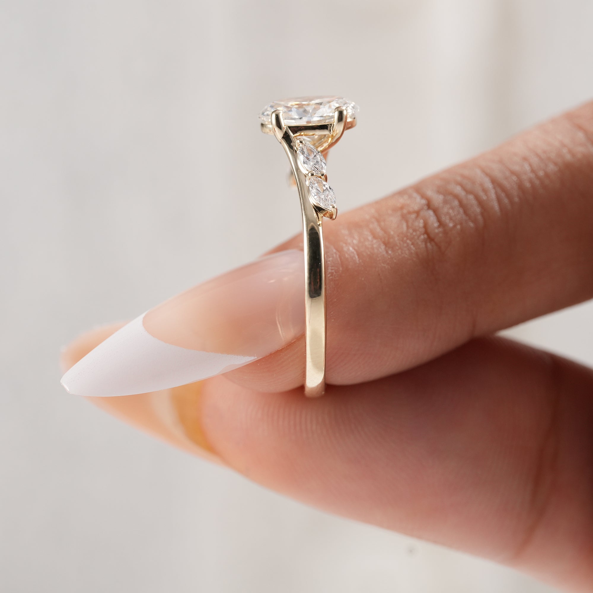 Oval cut lab diamond ring with botanical inspired band.