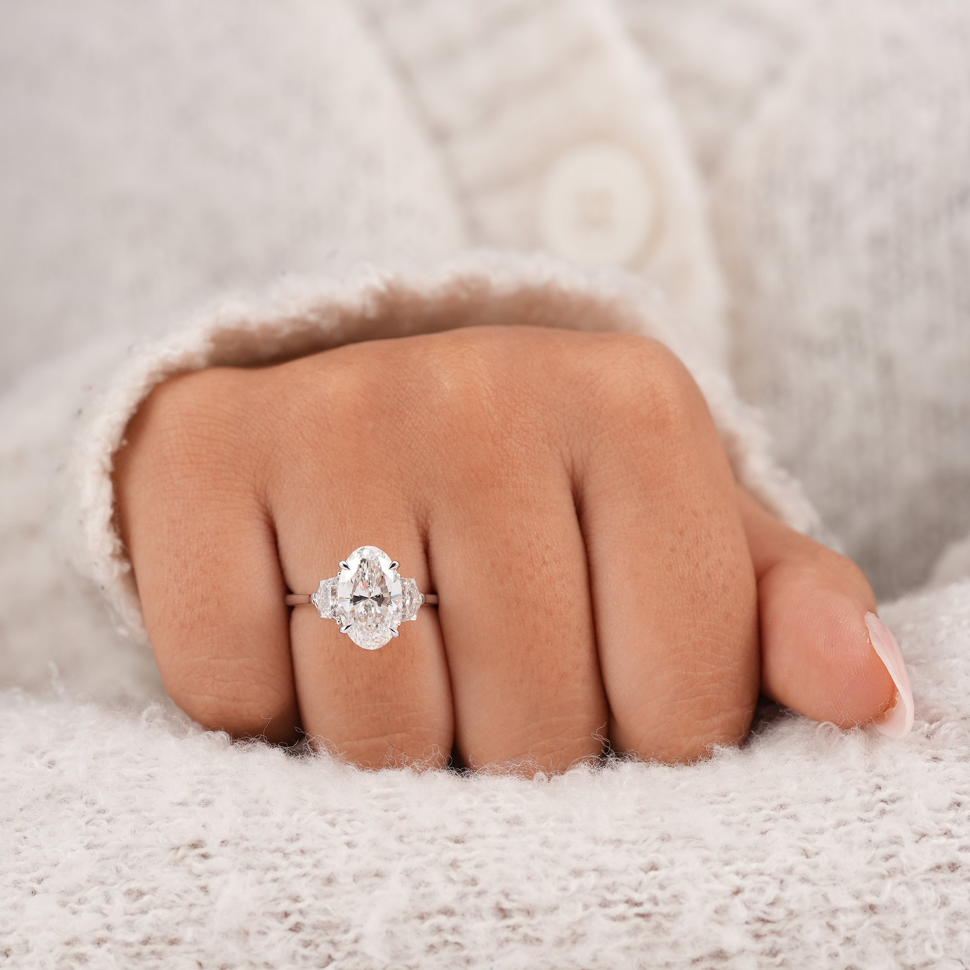 Women's oval diamond trilogy ring with brilliant Cadillac side diamonds