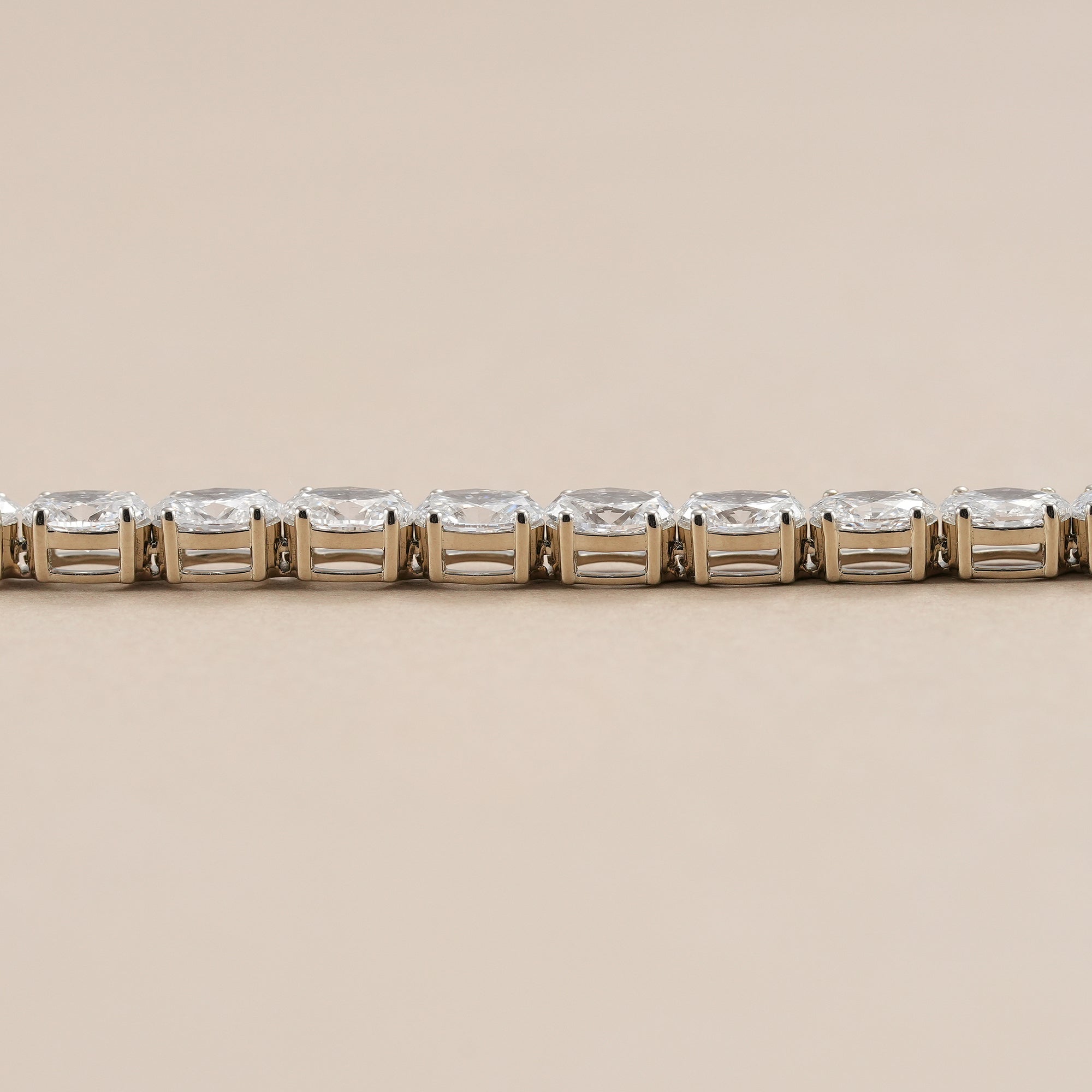 Luxury oval diamond tennis bracelet in polished white gold.