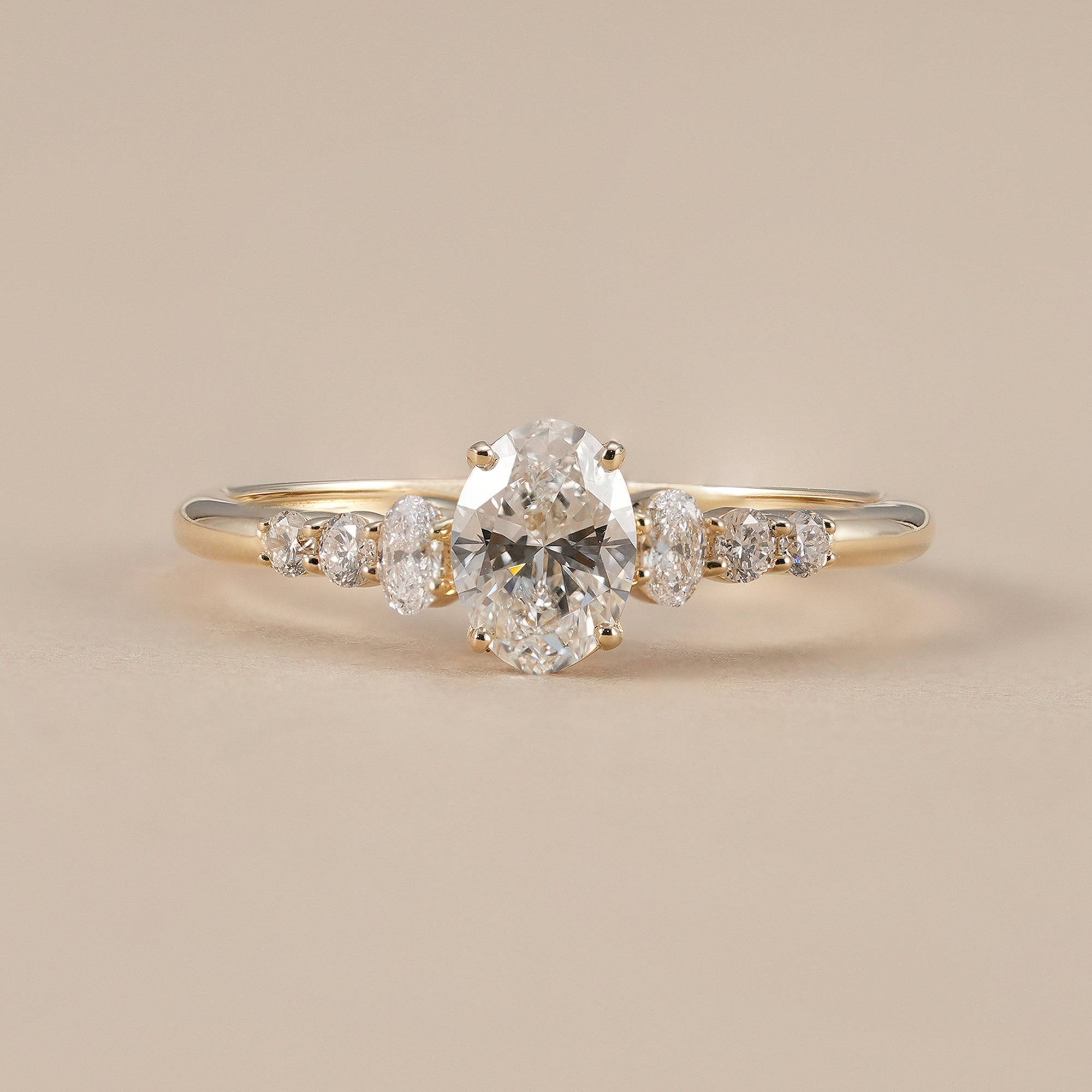 Oval lab grown diamond engagement ring with seven stone accents