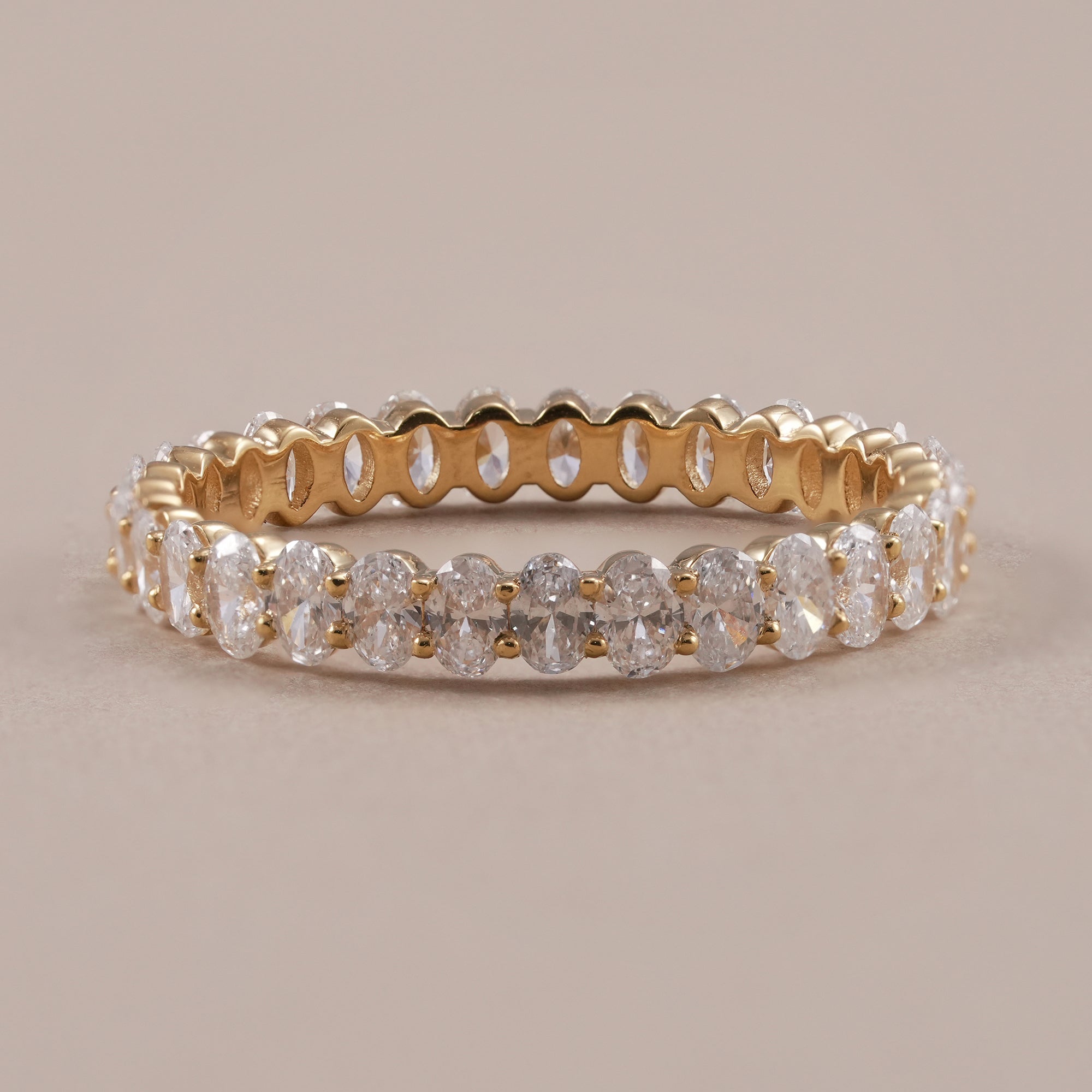 Oval cut lab grown diamond full eternity wedding ring in yellow gold.