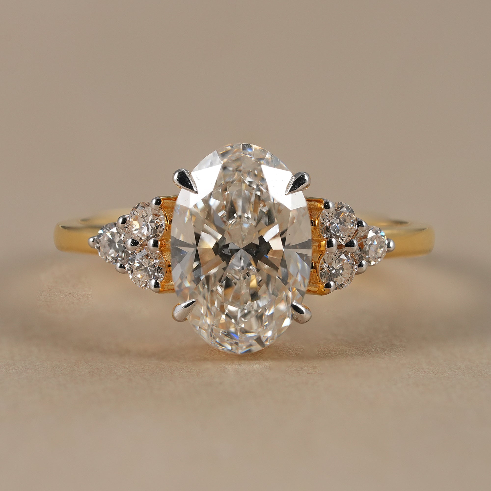 Oval lab grown diamond floral cluster engagement ring in yellow gold