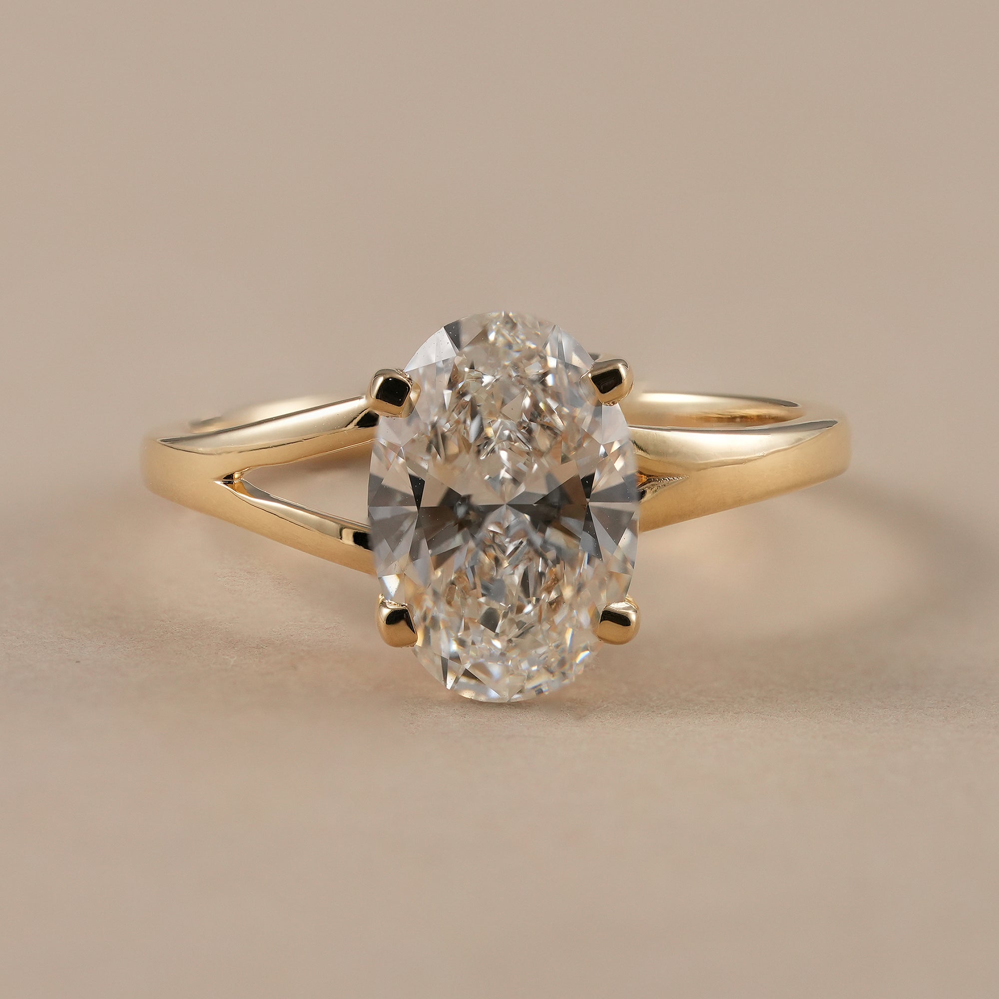 Oval lab grown diamond split shank engagement ring in yellow gold