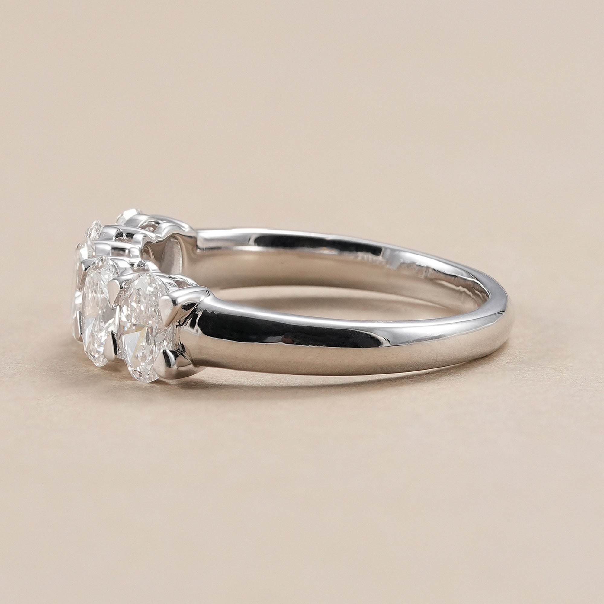 Elegant oval diamond anniversary ring with shared prong setting.