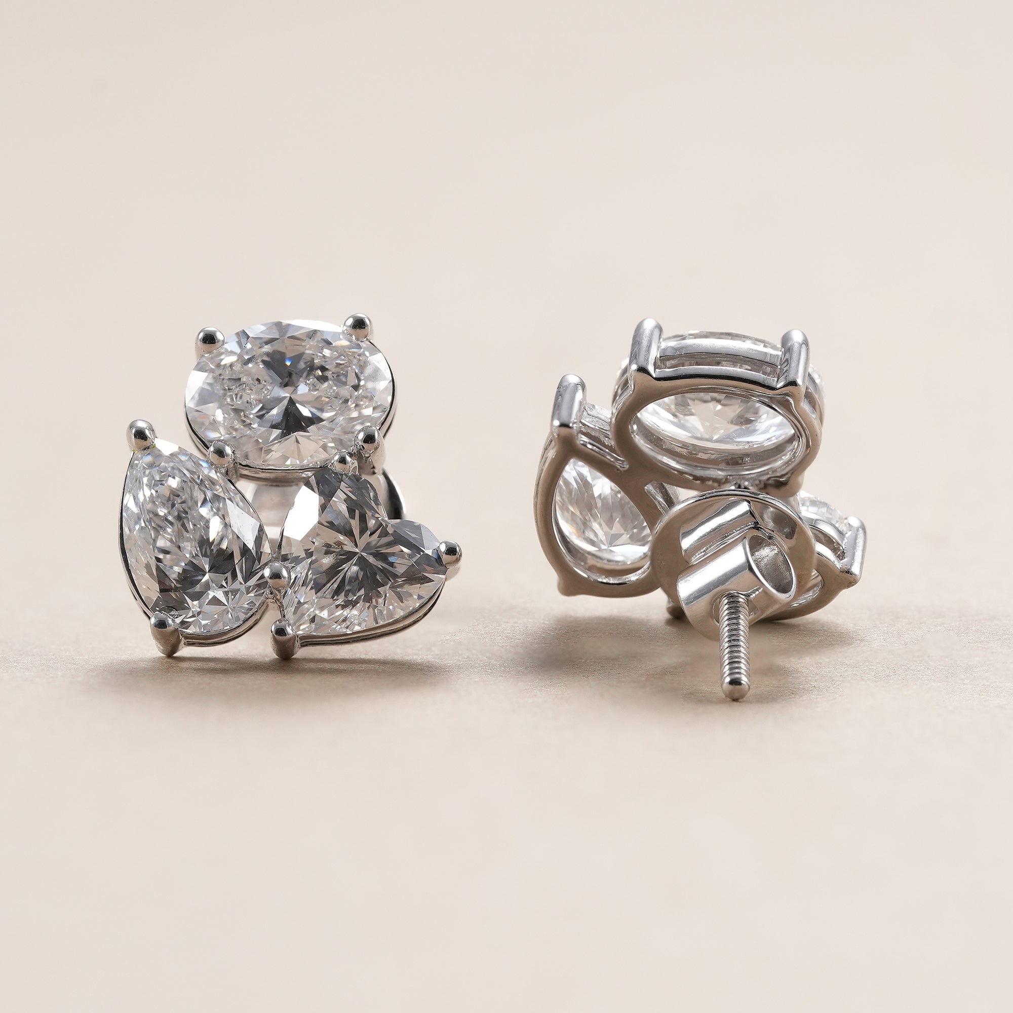 Elegant diamond cluster stud earrings handcrafted in white gold.