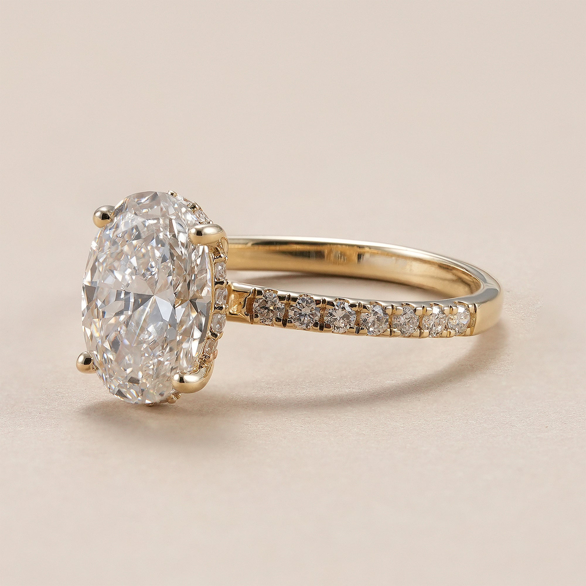 IGI certified oval diamond engagement ring with hidden halo setting.