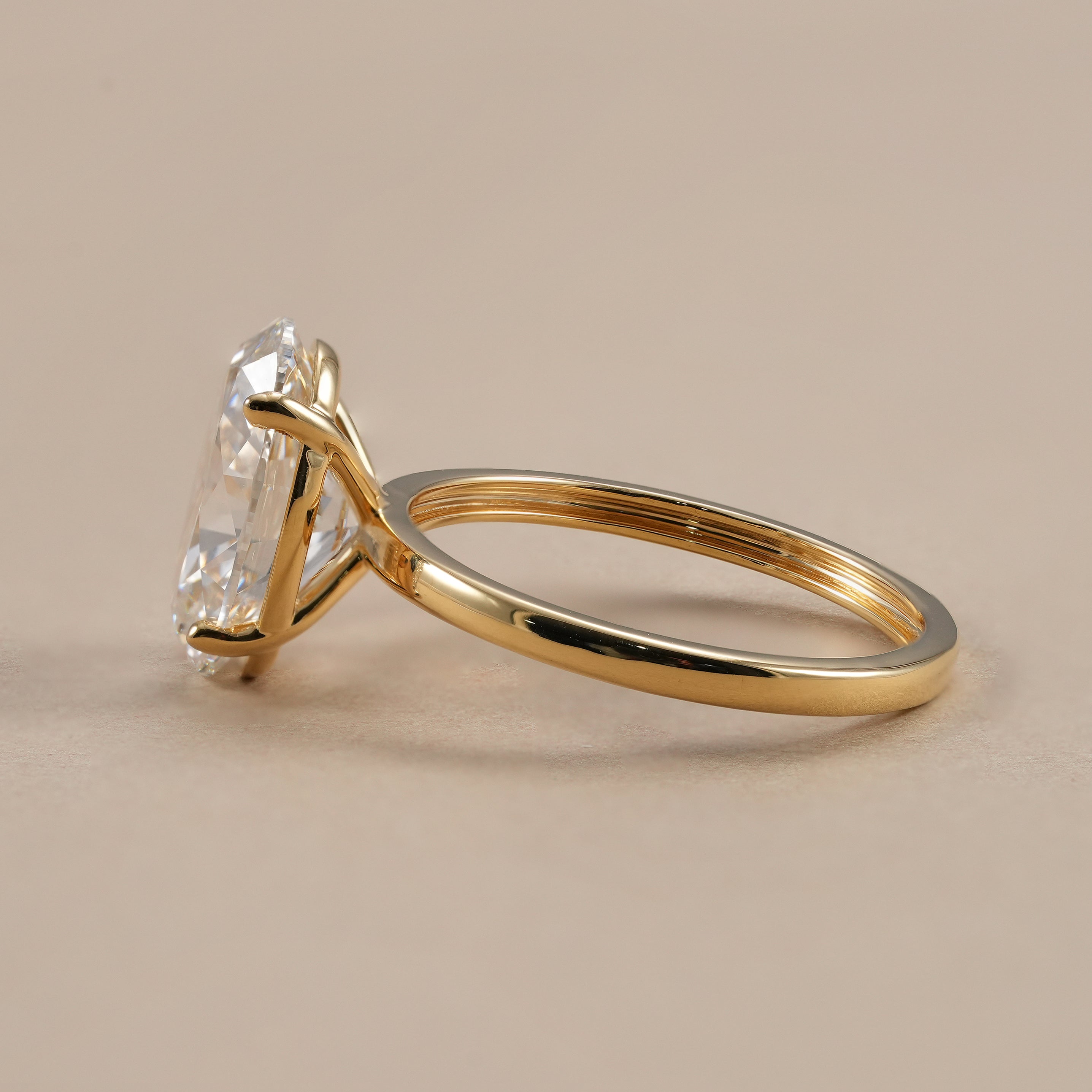 IGI certified oval lab diamond ring with polished gold band.