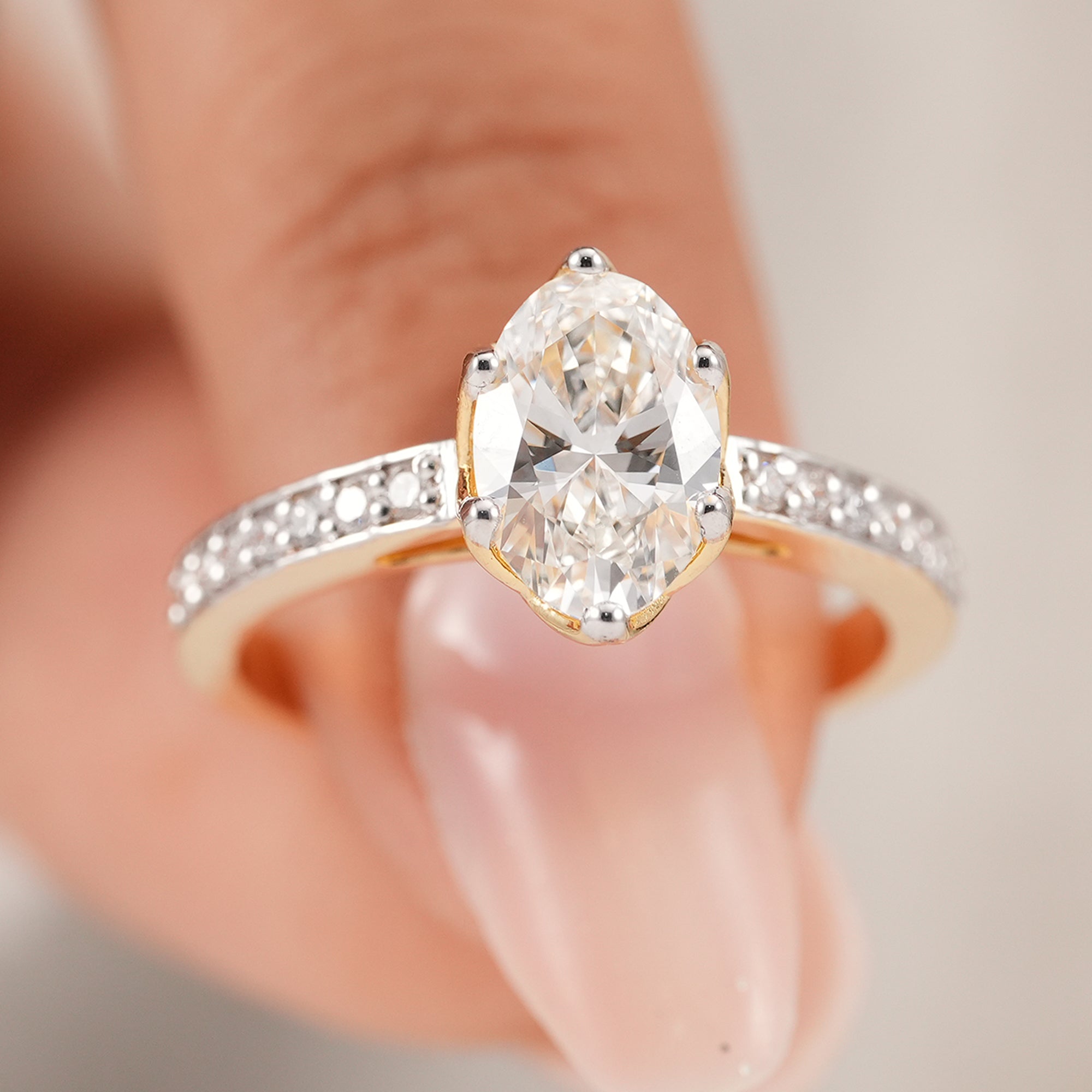 Oval solitaire lab diamond ring in yellow gold with pavé setting