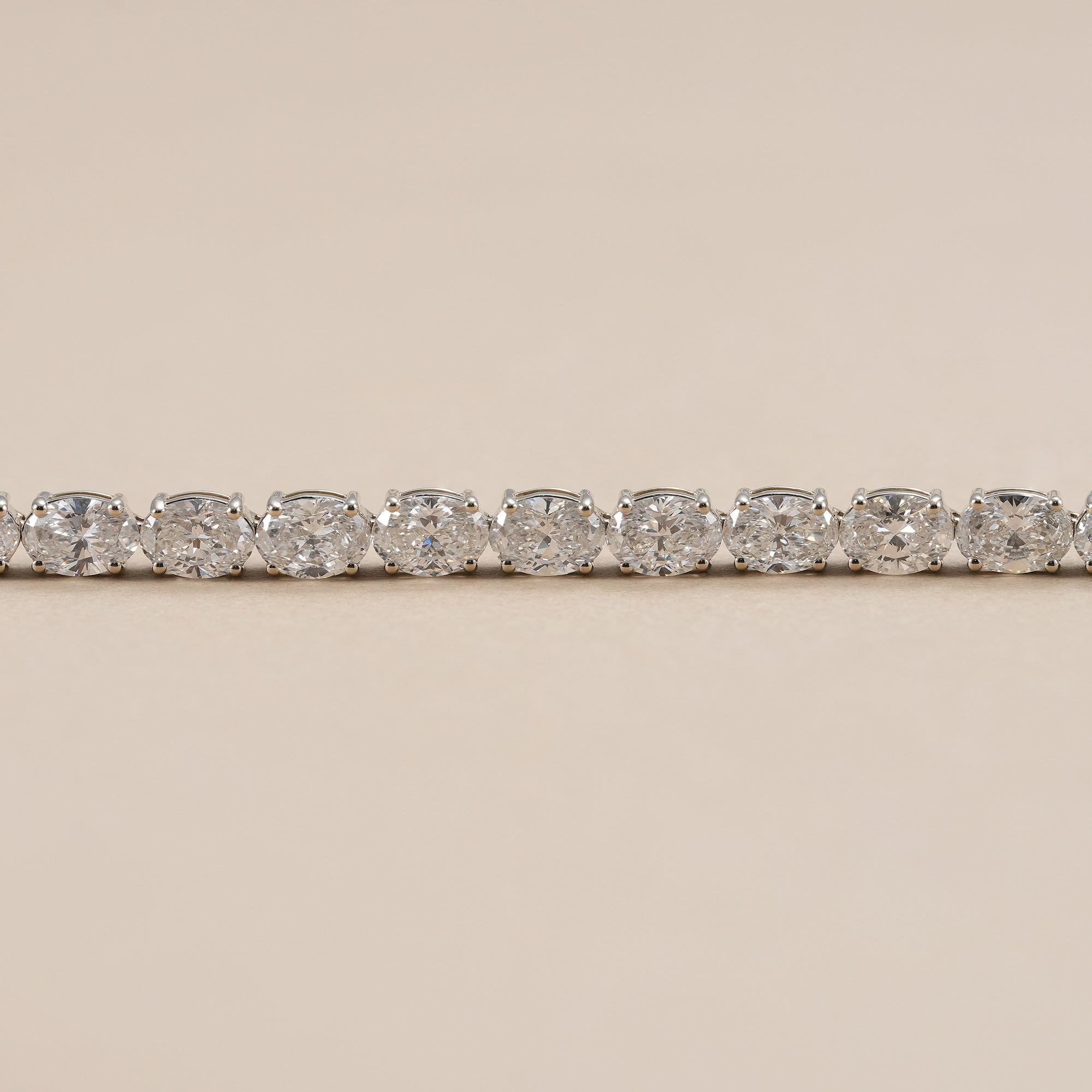 Oval lab diamond tennis bracelet with elegant east west diamond setting.