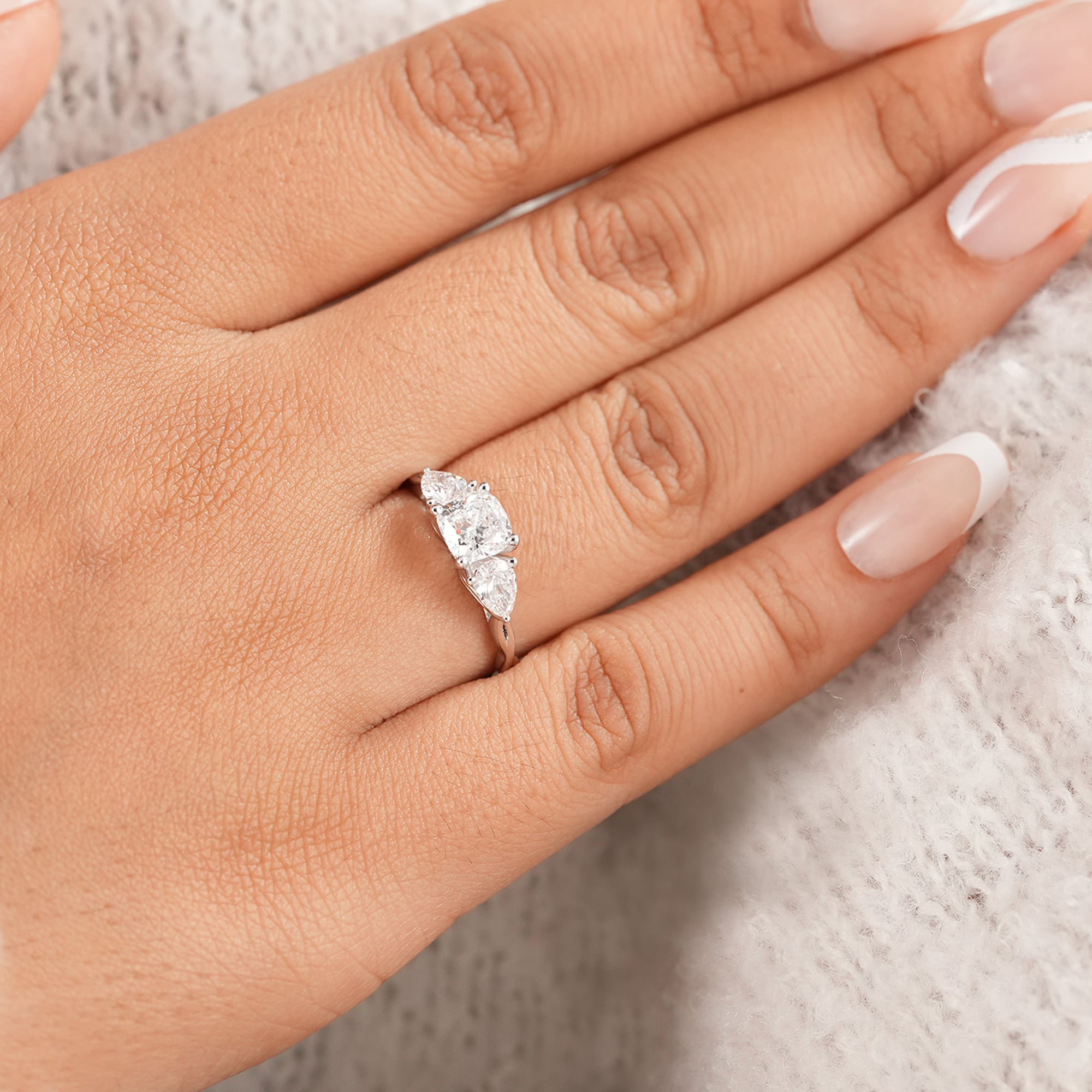 Cushion cut bridal ring featuring pear accent diamonds