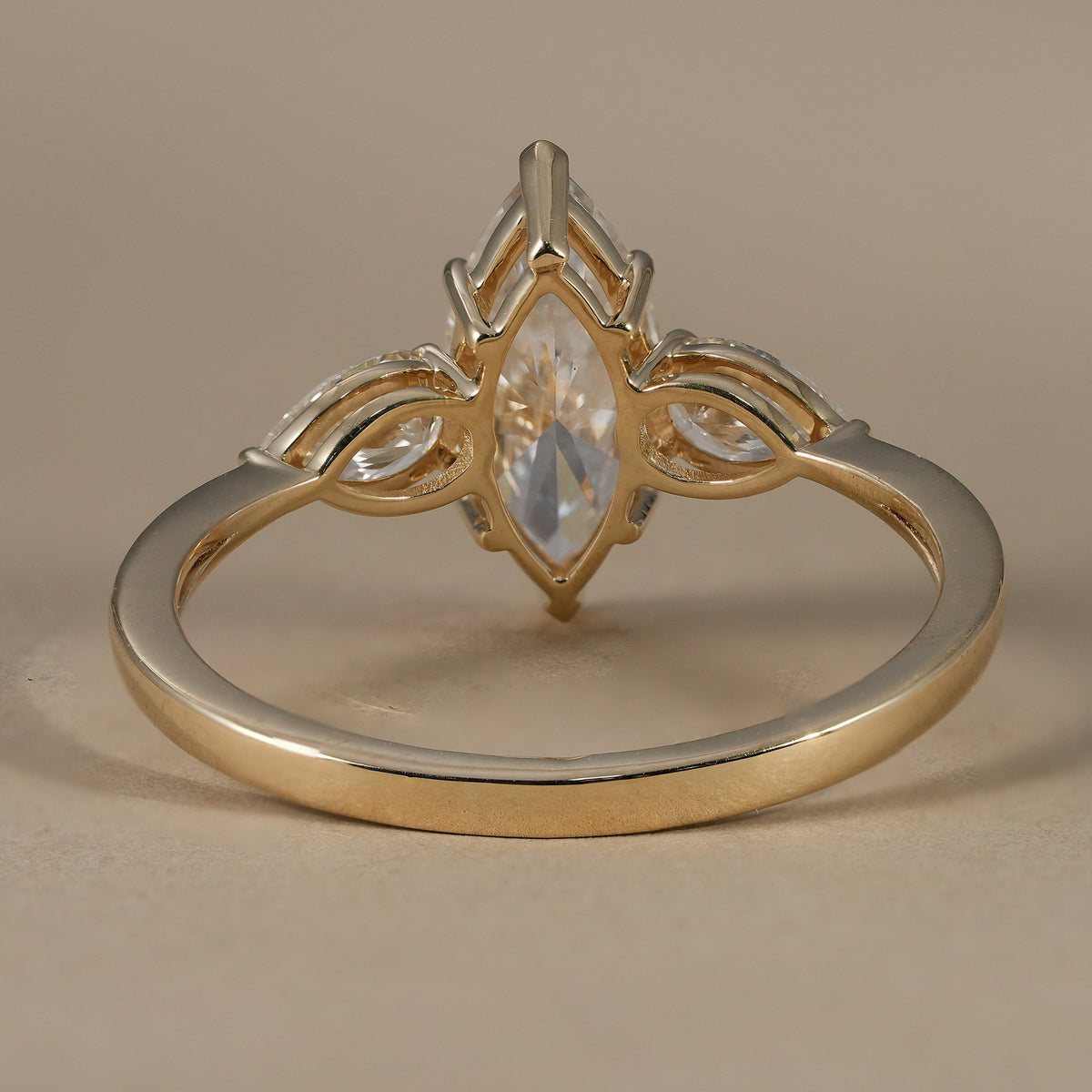 Sustainable IGI certified marquise diamond engagement ring with classic three stone style.