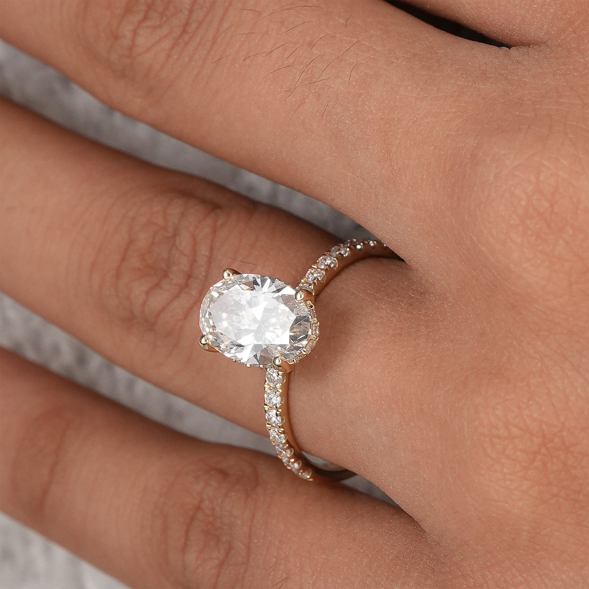Handcrafted oval diamond engagement ring in solid gold.