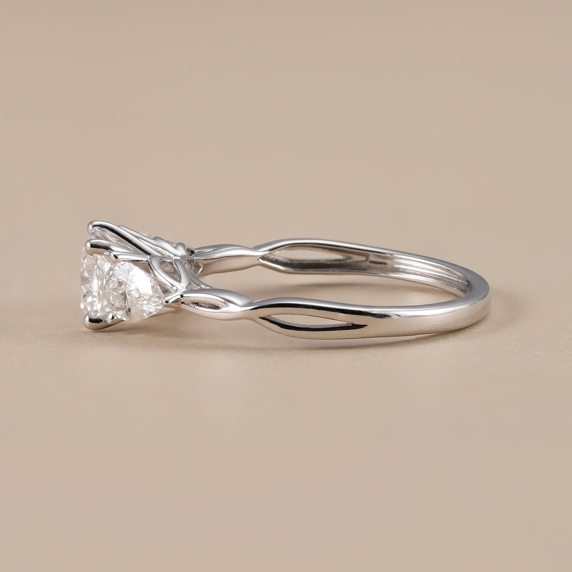 Elegant trilogy engagement ring with cushion center diamond