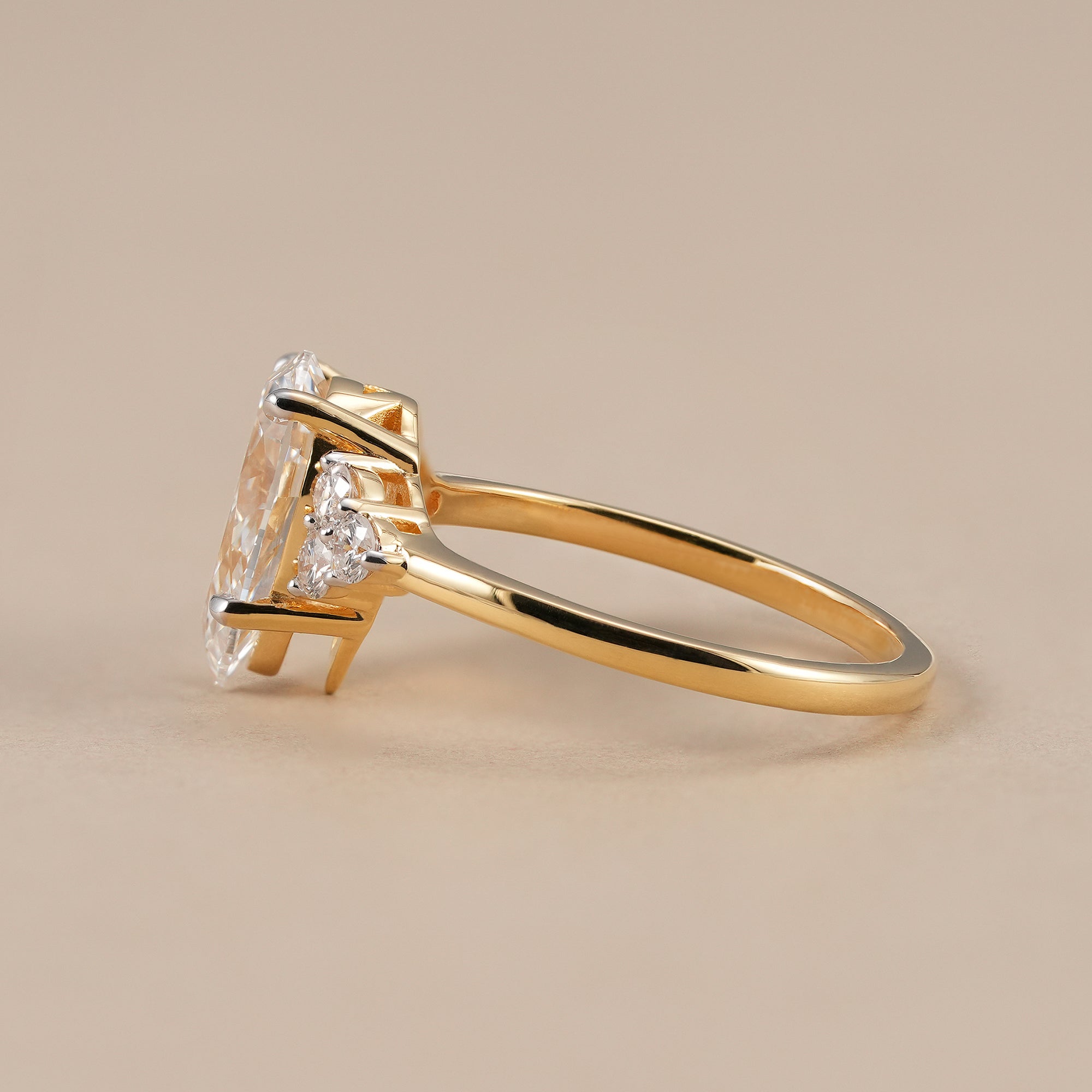 Pear solitaire diamond ring with round diamond cluster accents