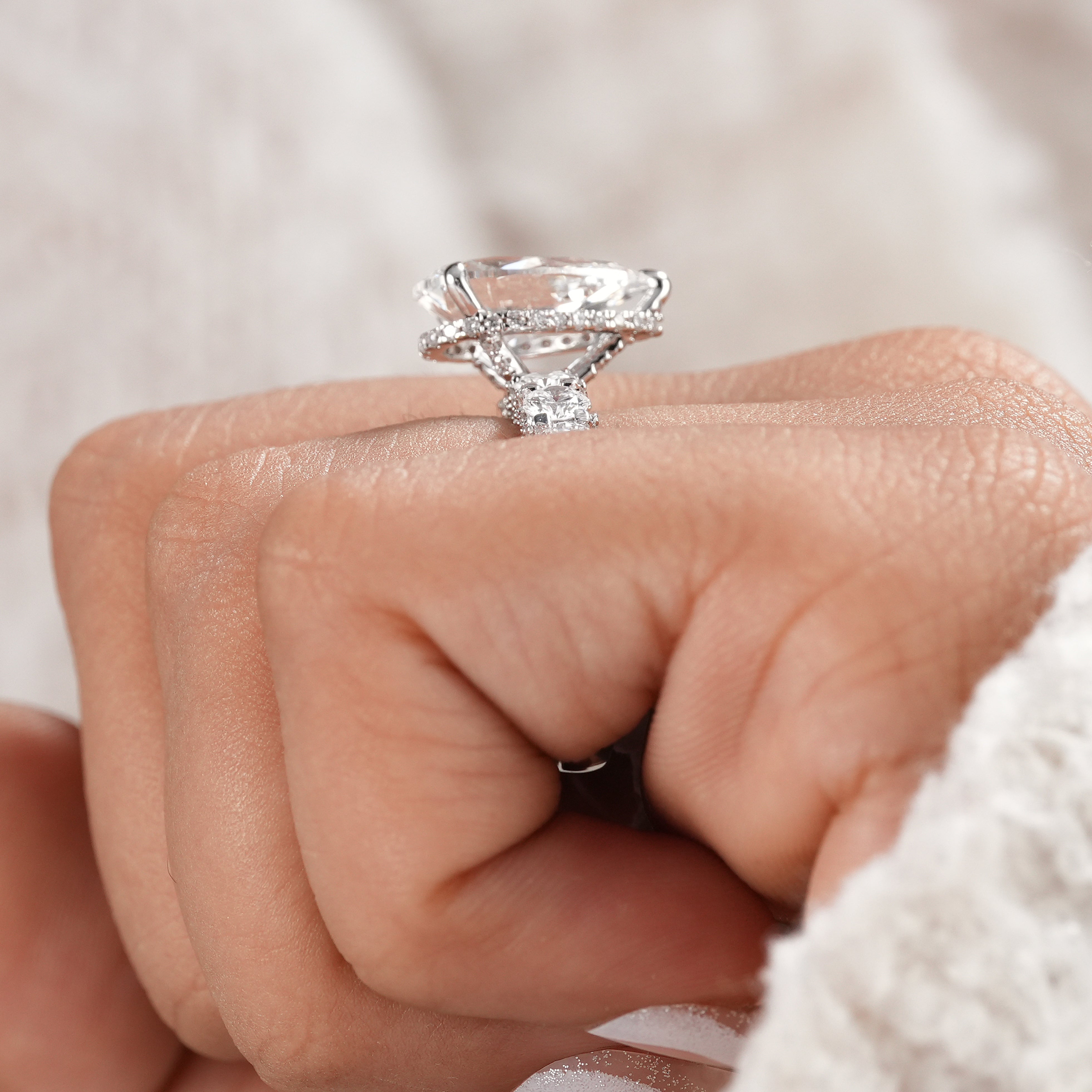 Pear diamond engagement ring with pavé diamond band.