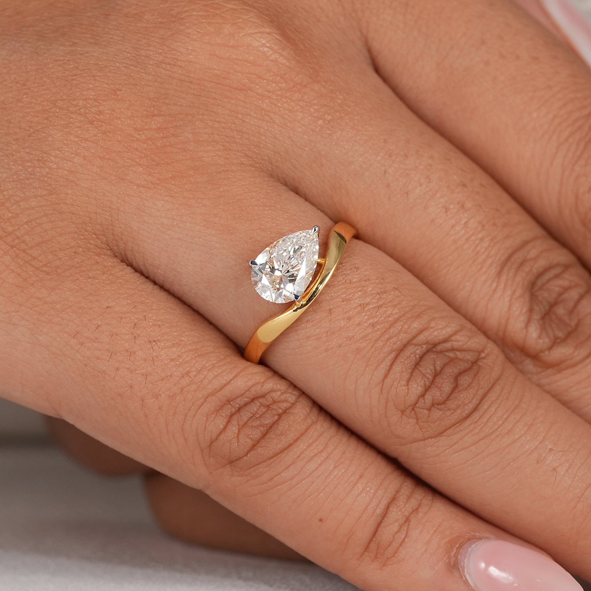 Modern curved pear solitaire proposal ring
