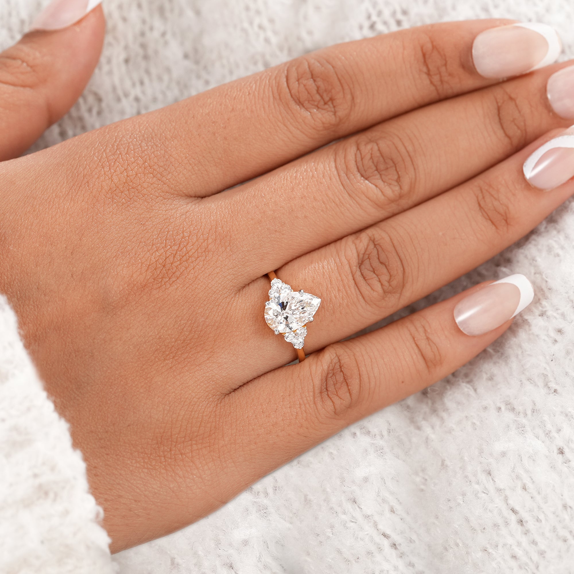 Women's pear diamond anniversary ring with floral setting