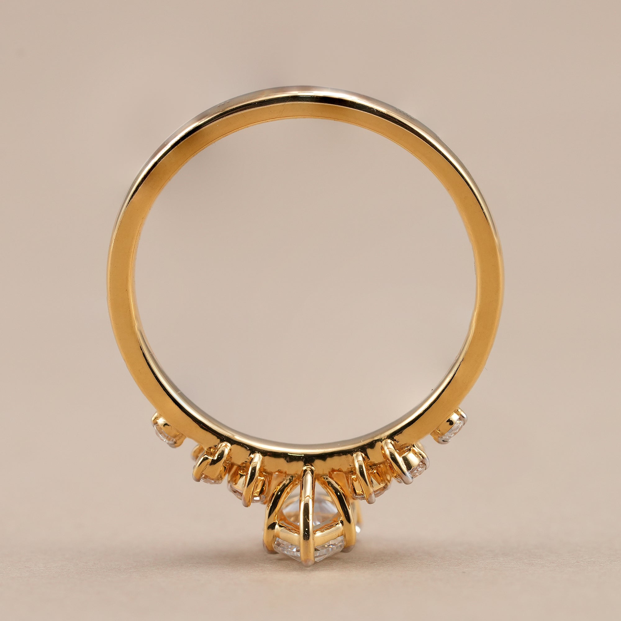 Pear diamond cluster ring with brilliant round side diamonds