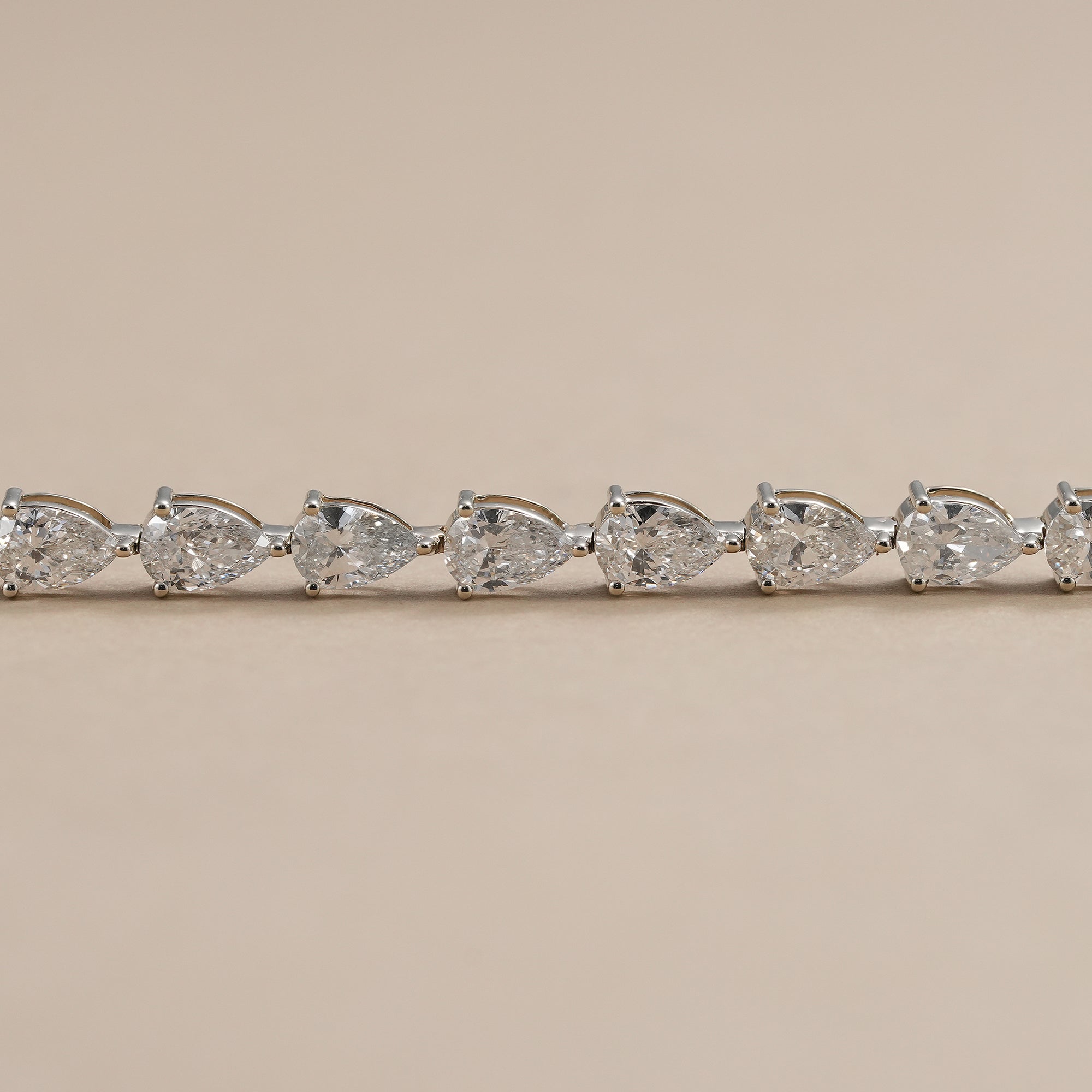 Elegant pear diamond bracelet handcrafted in white gold.