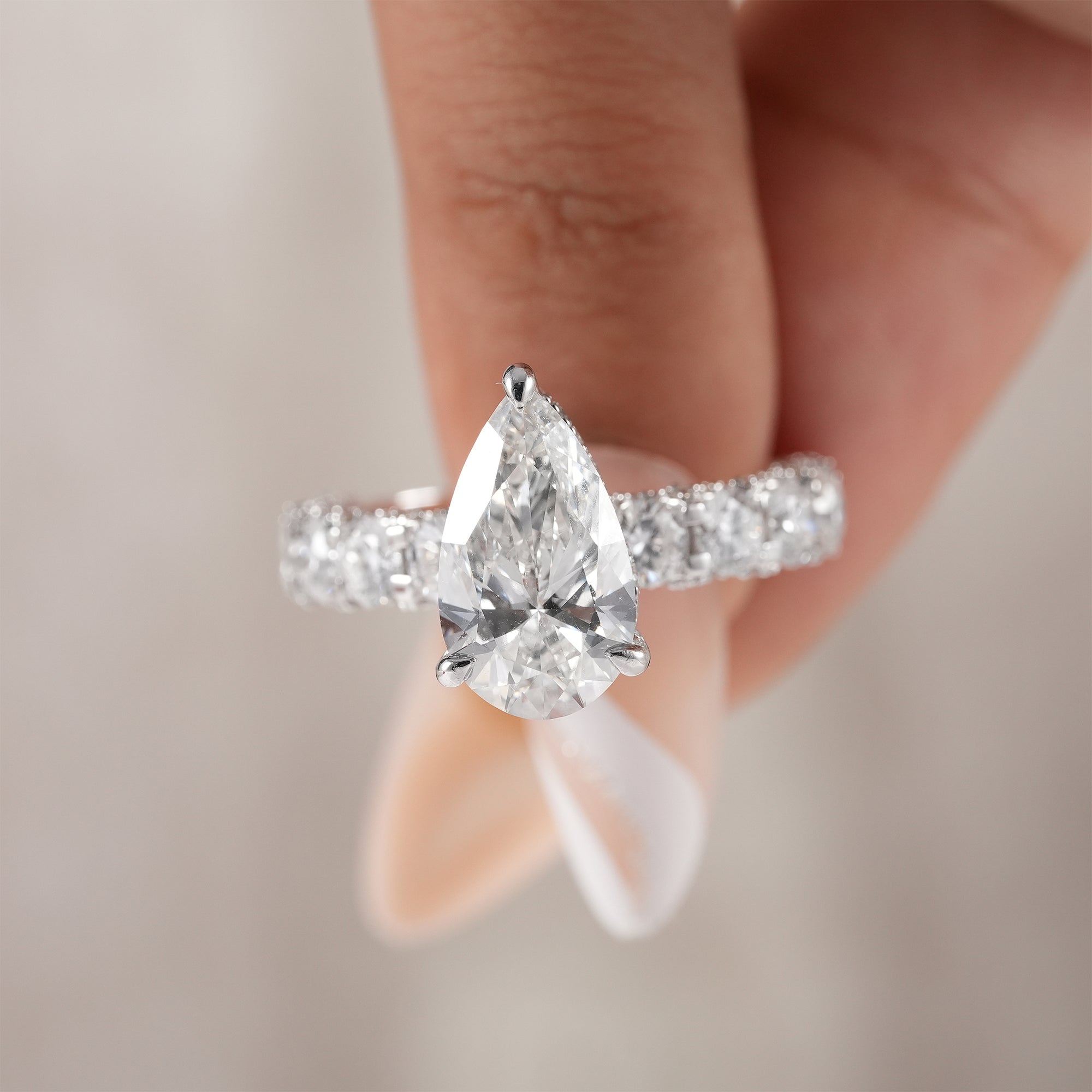 Elegant pear cut engagement ring handcrafted in white gold.