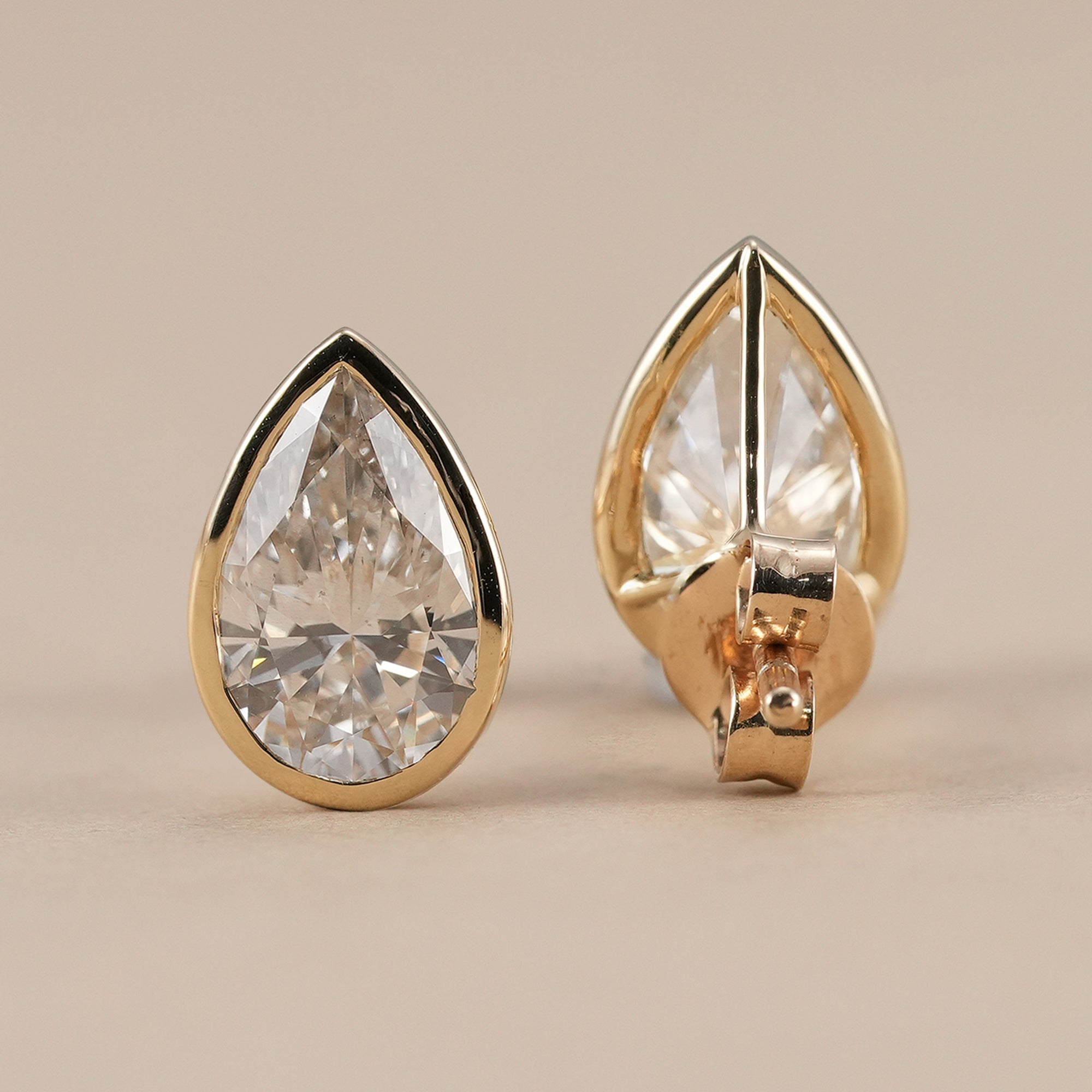Minimalist pear bezel diamond stud earrings