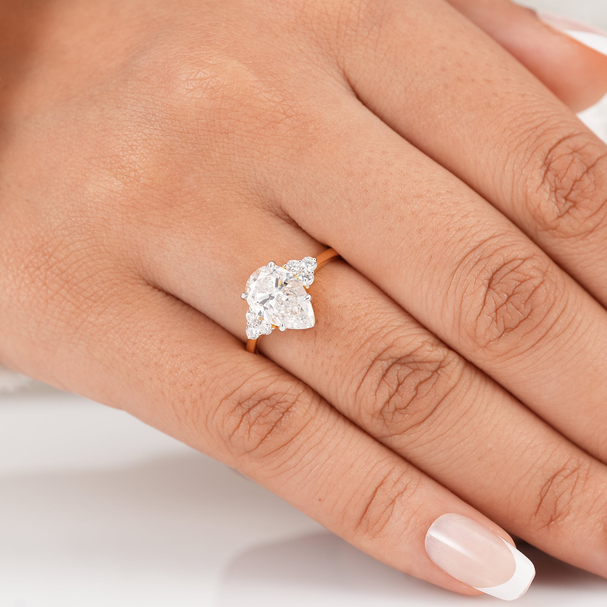 Solid gold pear engagement ring with brilliant lab grown diamond