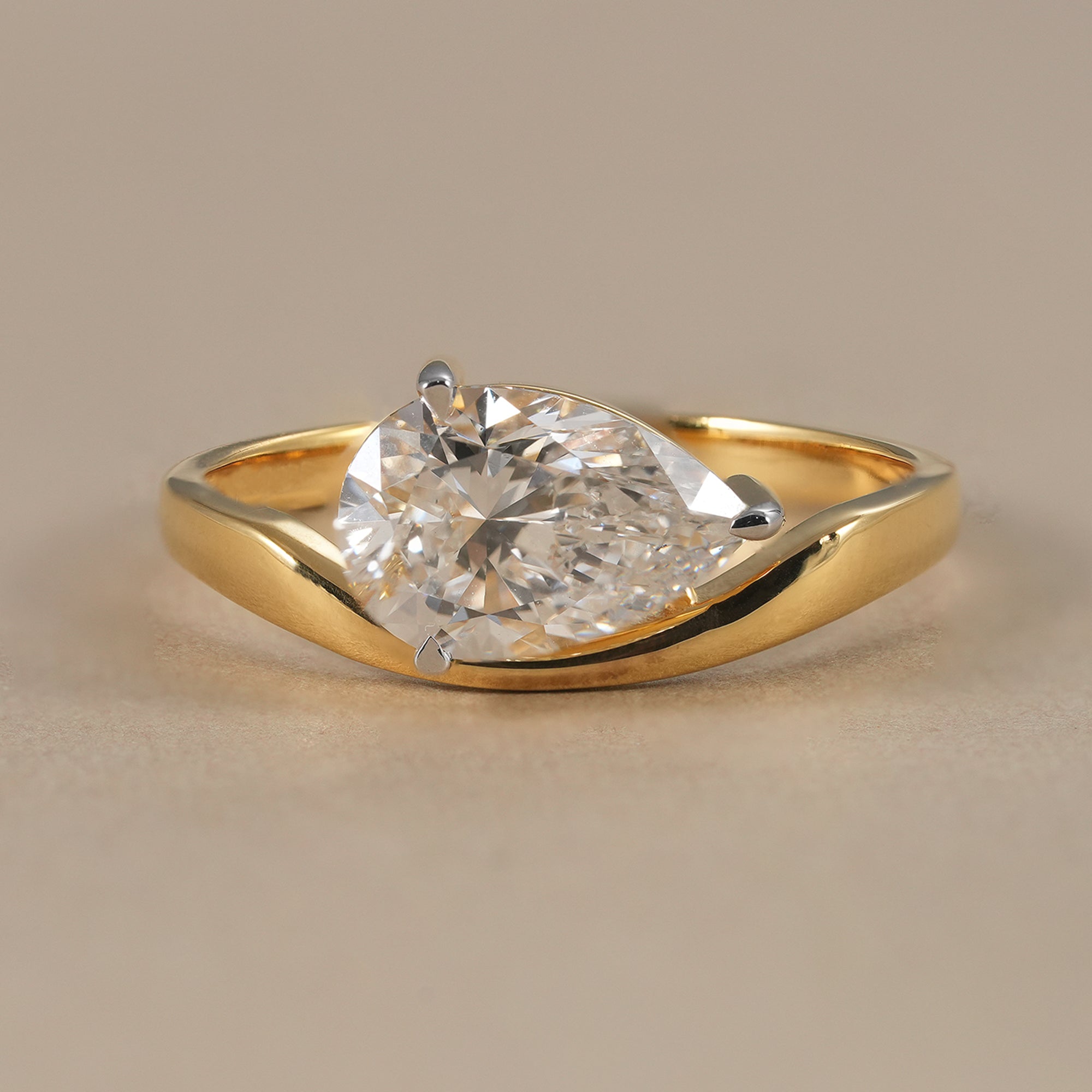 Pear lab grown diamond bypass engagement ring in yellow gold