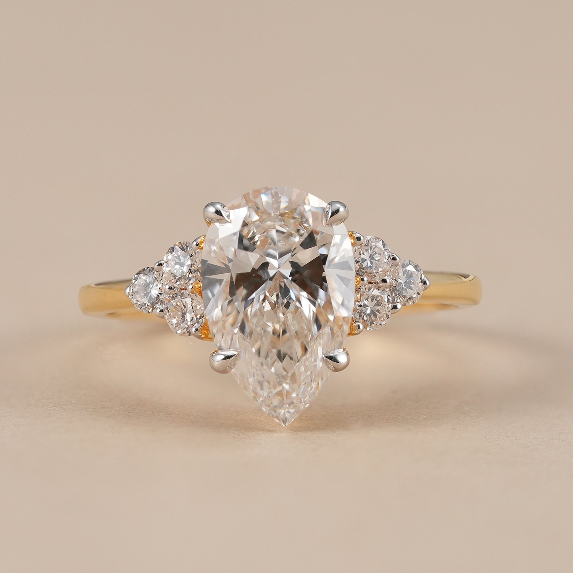 Pear lab grown diamond cluster engagement ring in solid yellow gold