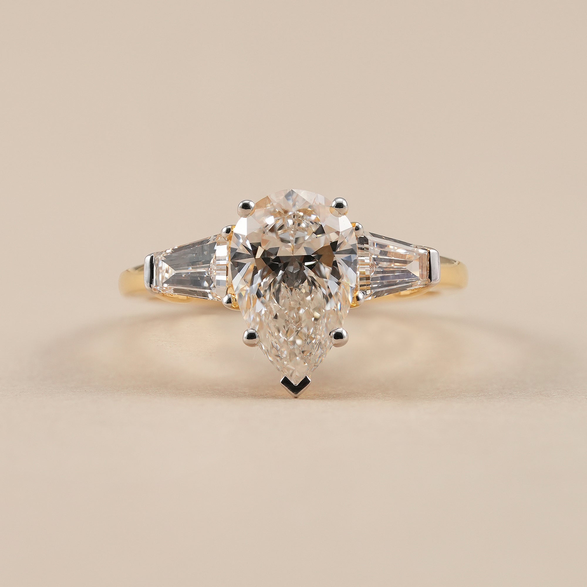 Pear lab grown diamond engagement ring with tapered baguette side diamonds