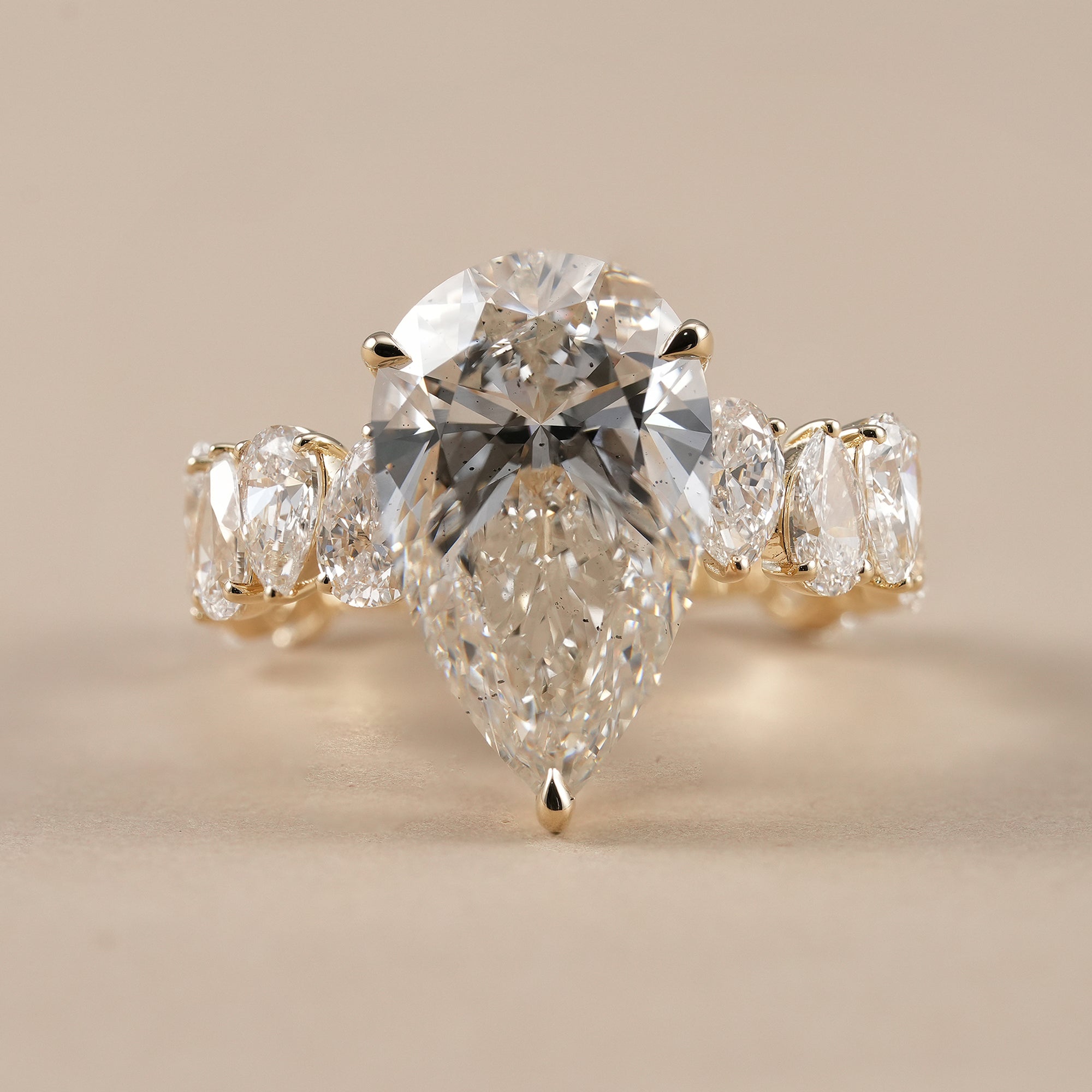 Pear lab grown diamond engagement ring with marquise side stones