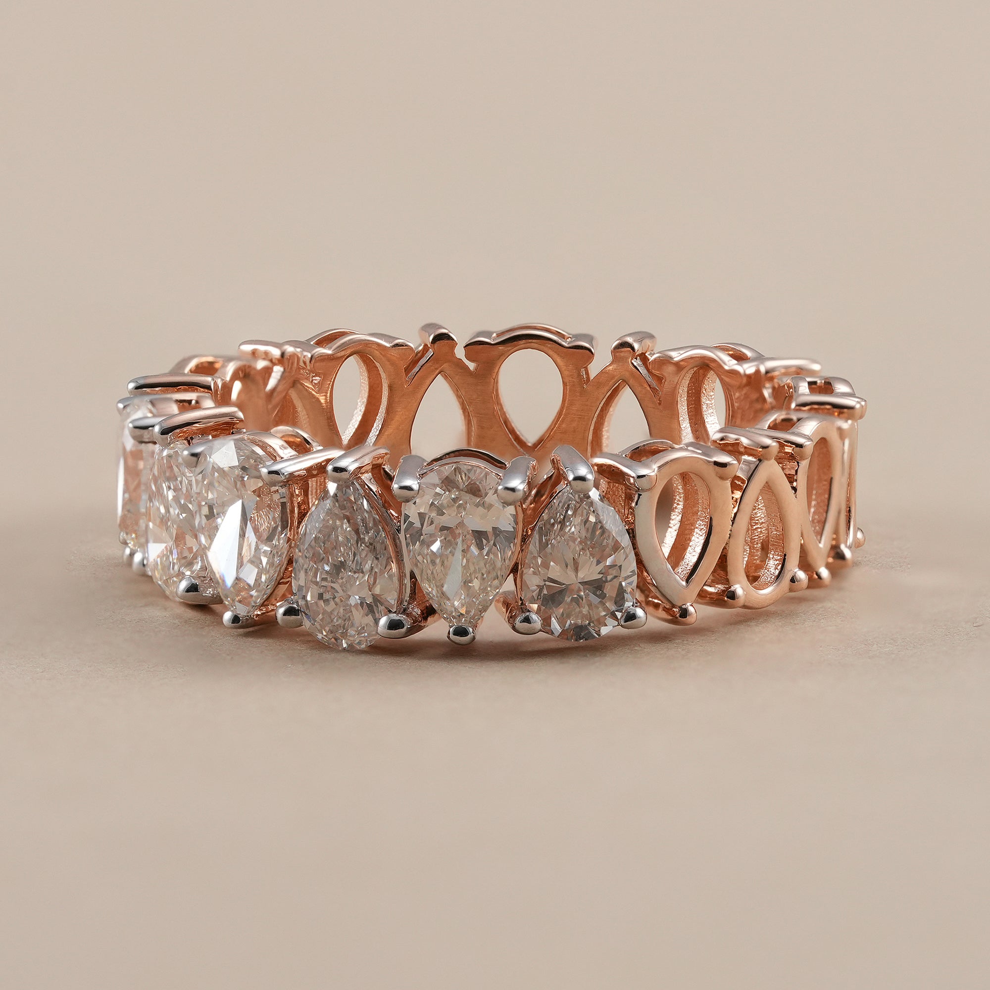 Full eternity pear diamond wedding band handcrafted in rose gold.