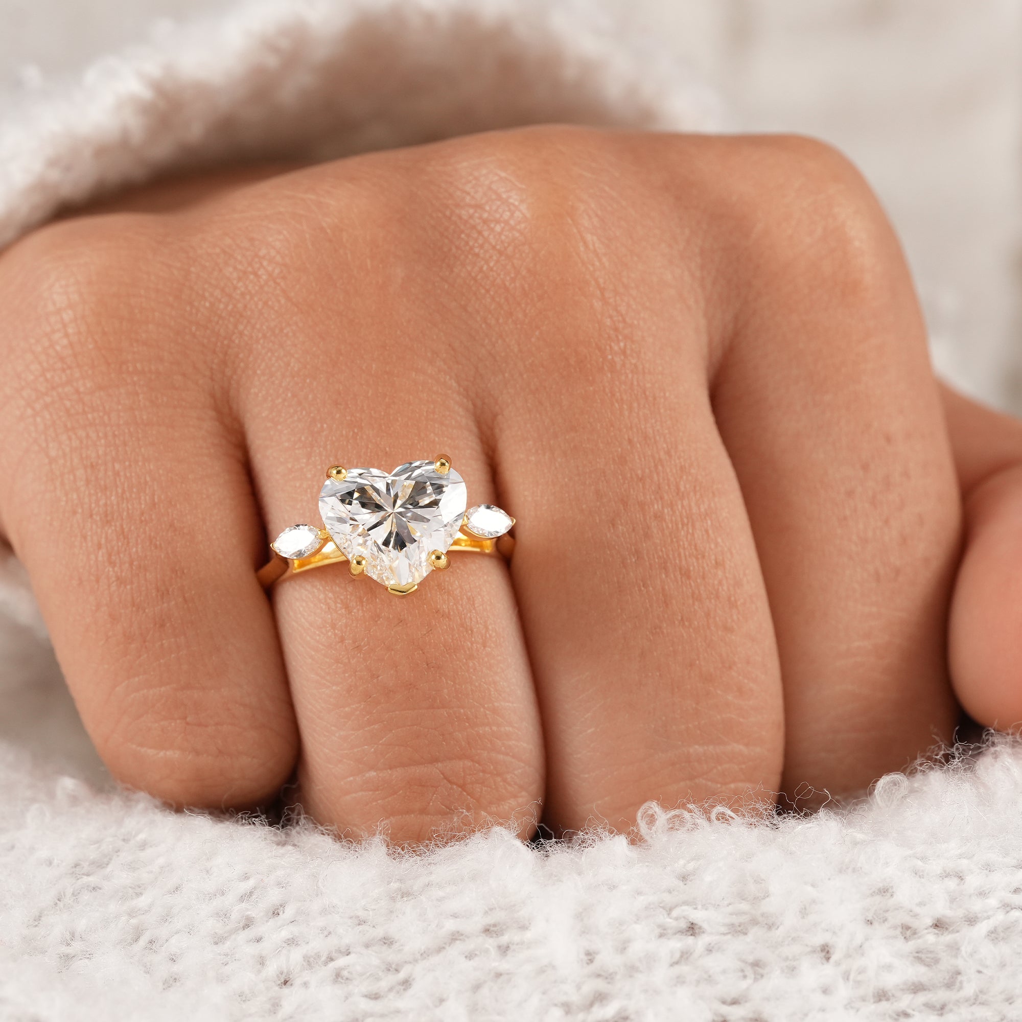 Ethical heart diamond engagement ring with pear side stones.