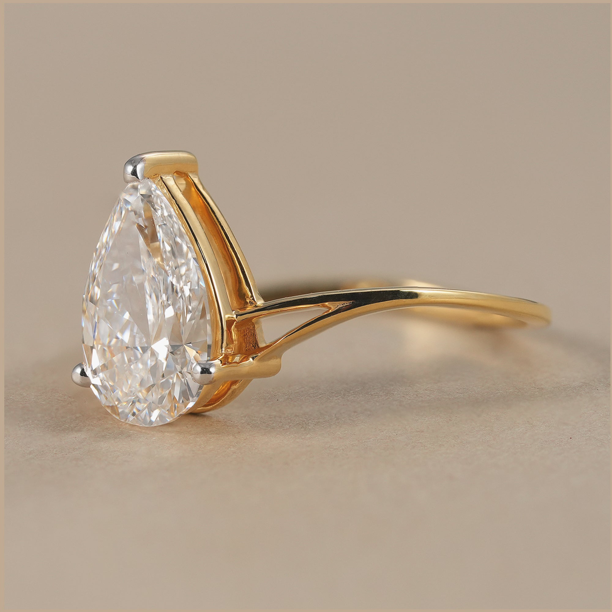 Elegant pear solitaire diamond ring with curved split band