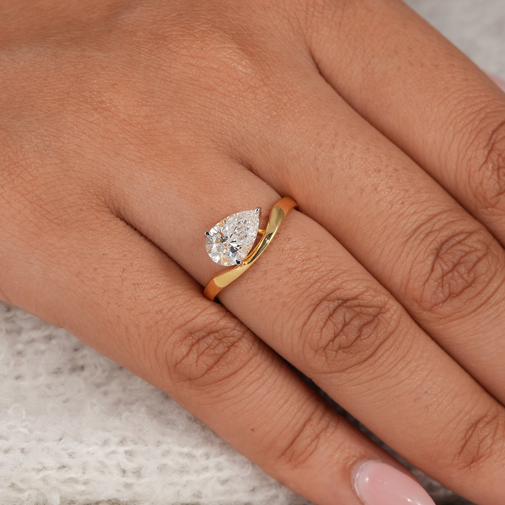 Elegant pear solitaire diamond ring with curved wave band