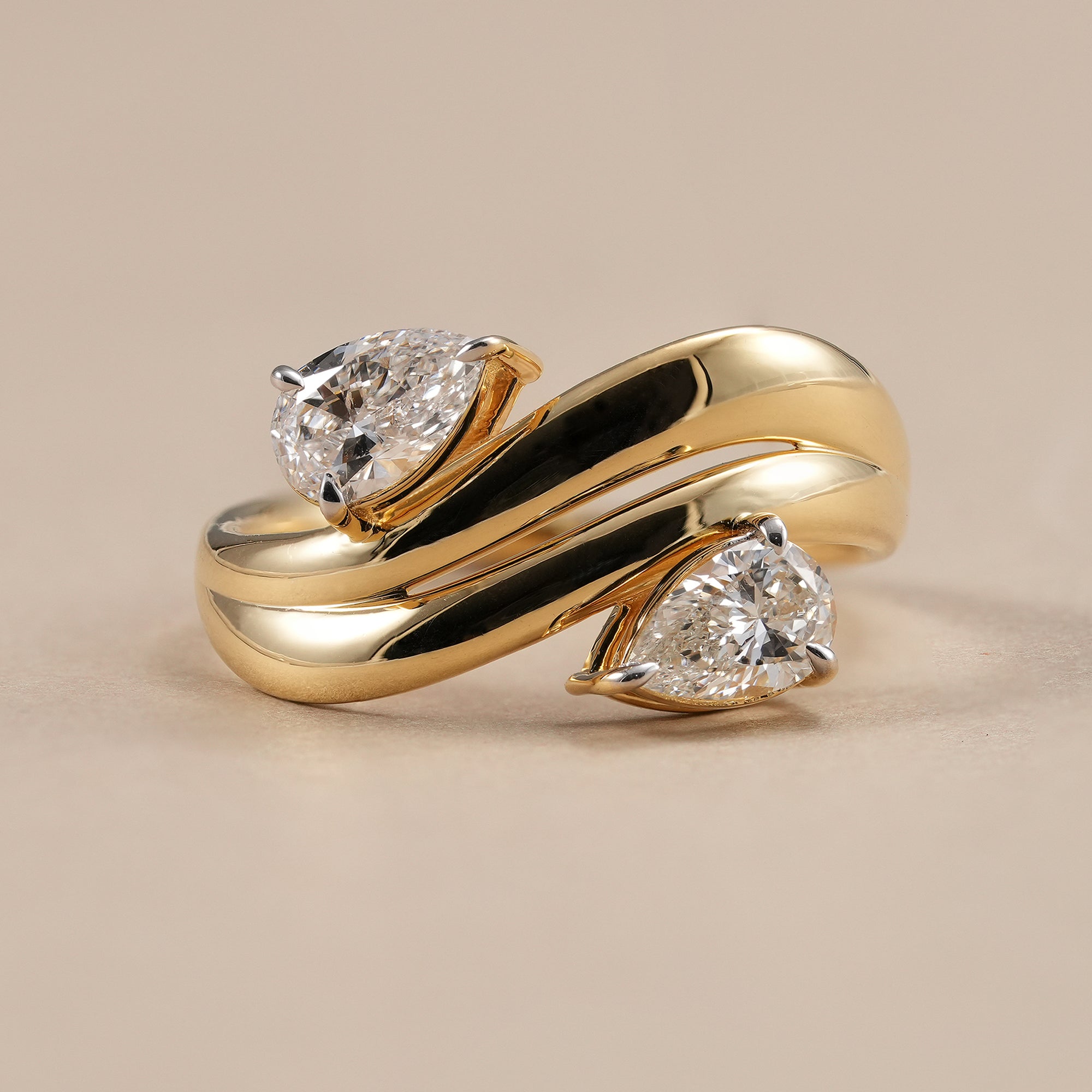 Chunky curved wave band featuring two pear lab grown diamonds in solid gold