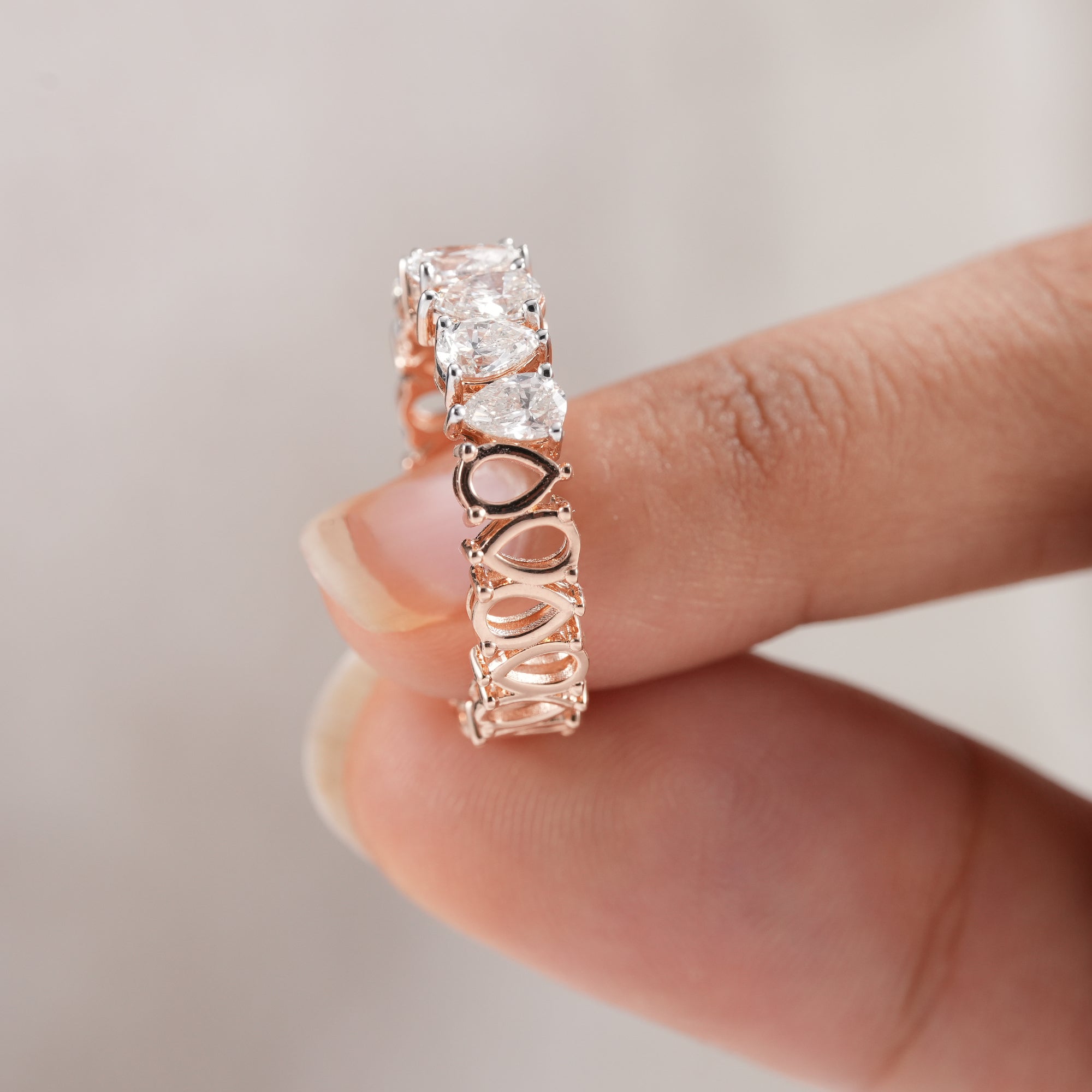 Women's pear diamond wedding band with continuous sparkle.