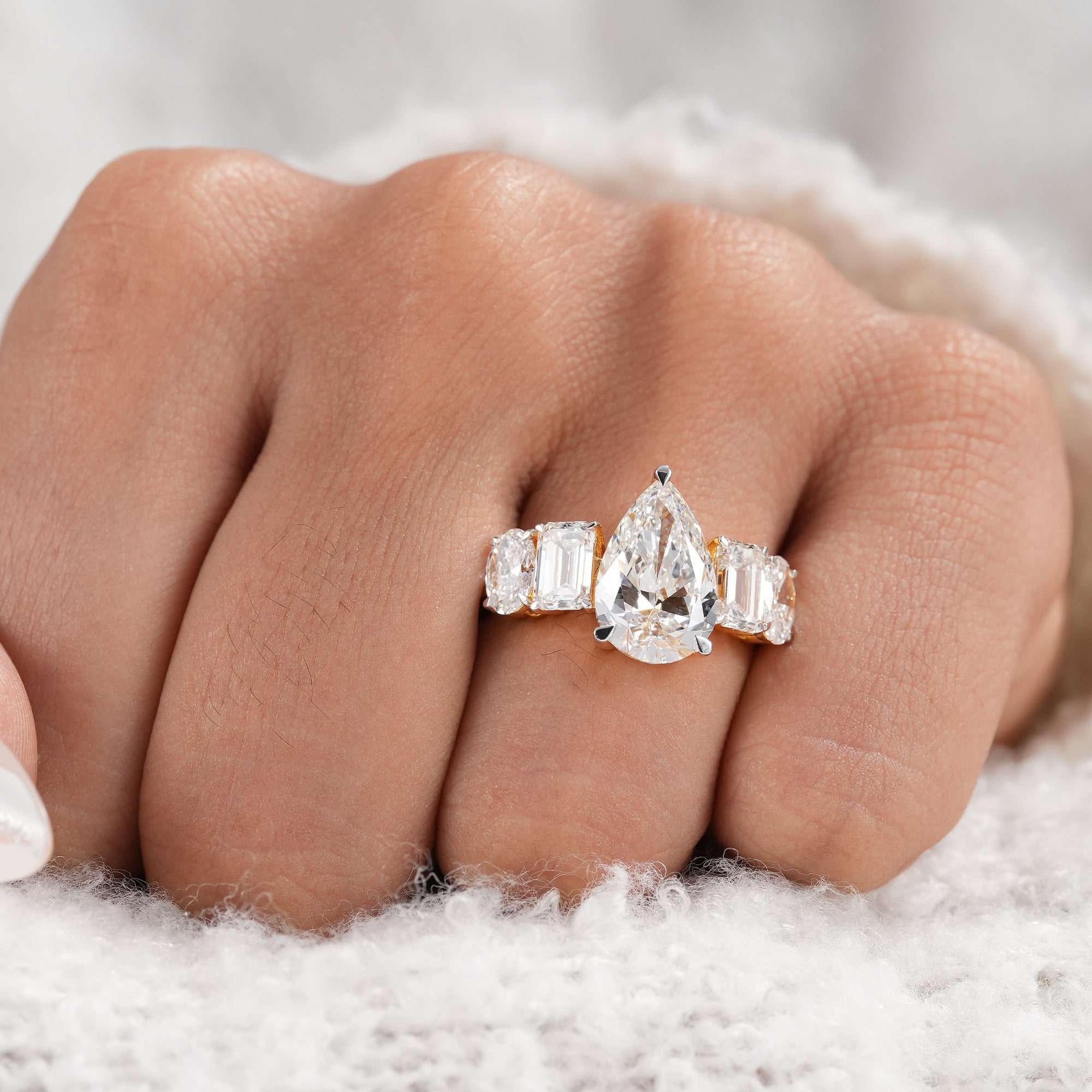 Fine jewelry pear engagement ring in polished yellow gold.