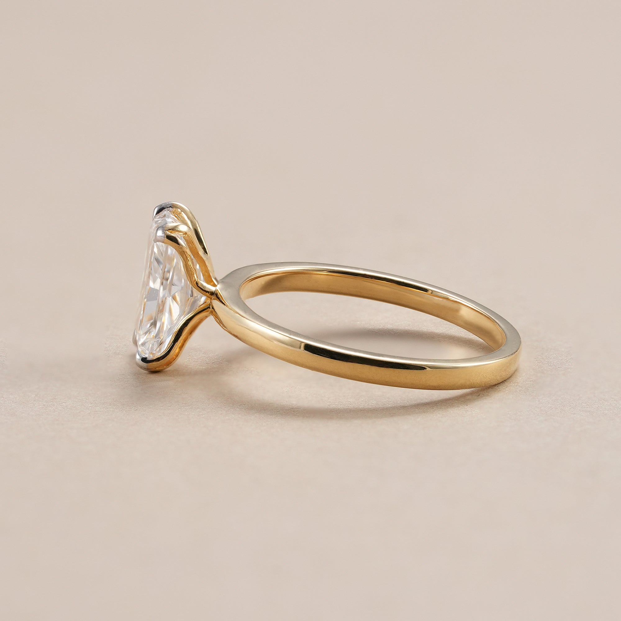 Four-prong radiant diamond solitaire ring handcrafted in solid yellow gold.