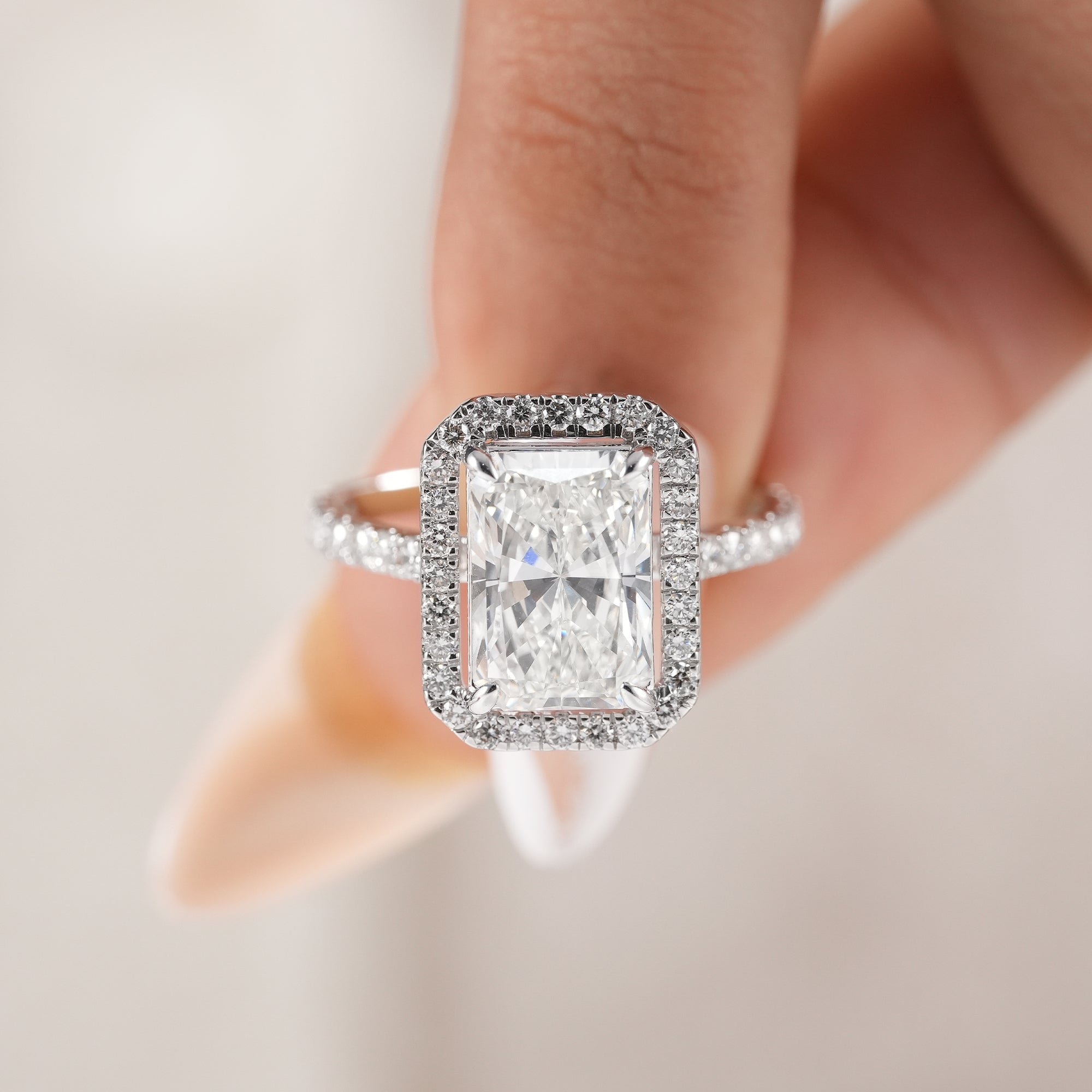 Radiant cut engagement ring with sparkling halo setting.
